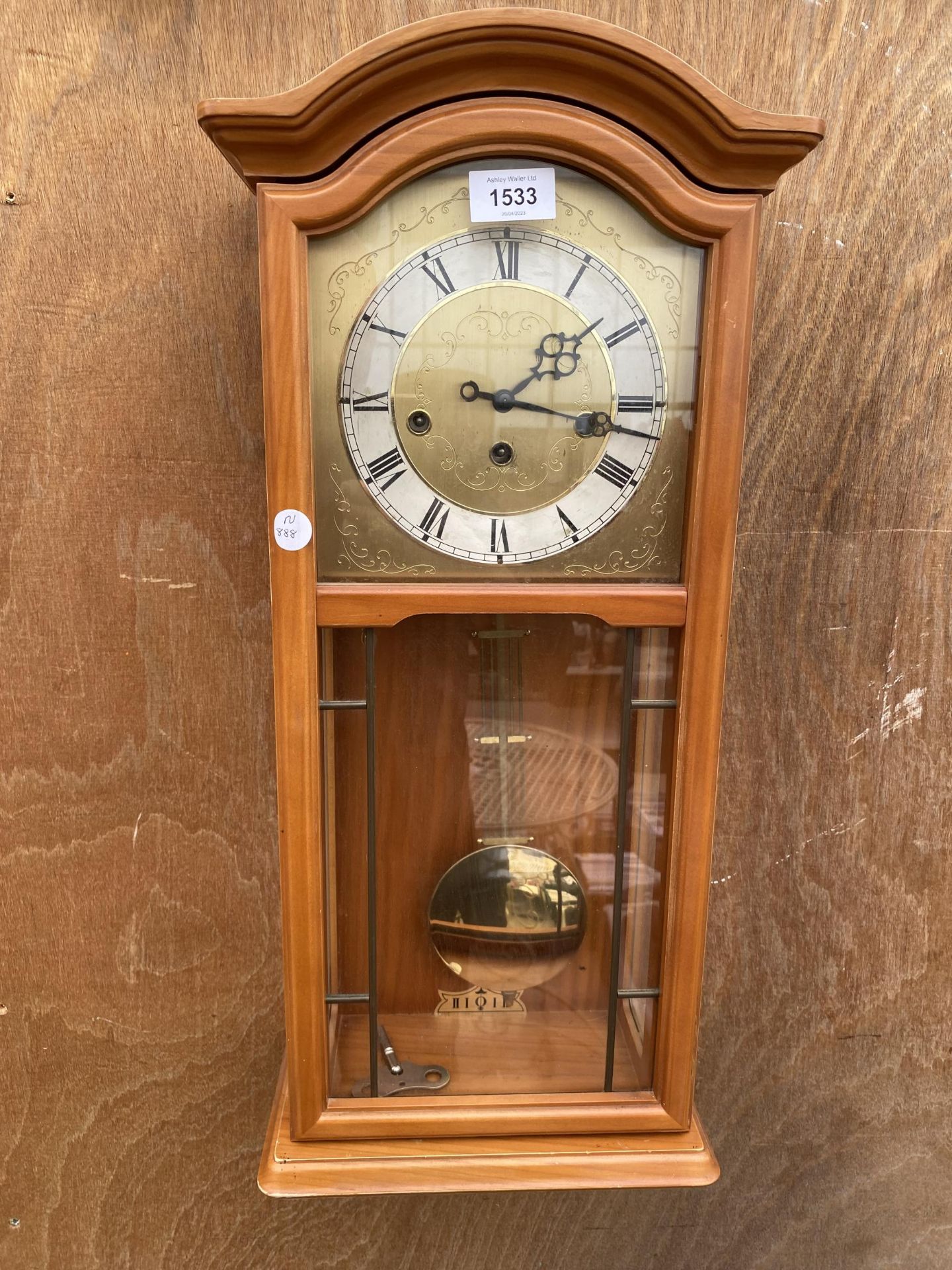 A WOODEN CASED WESTMINISTER CHIMING WALL CLOCK