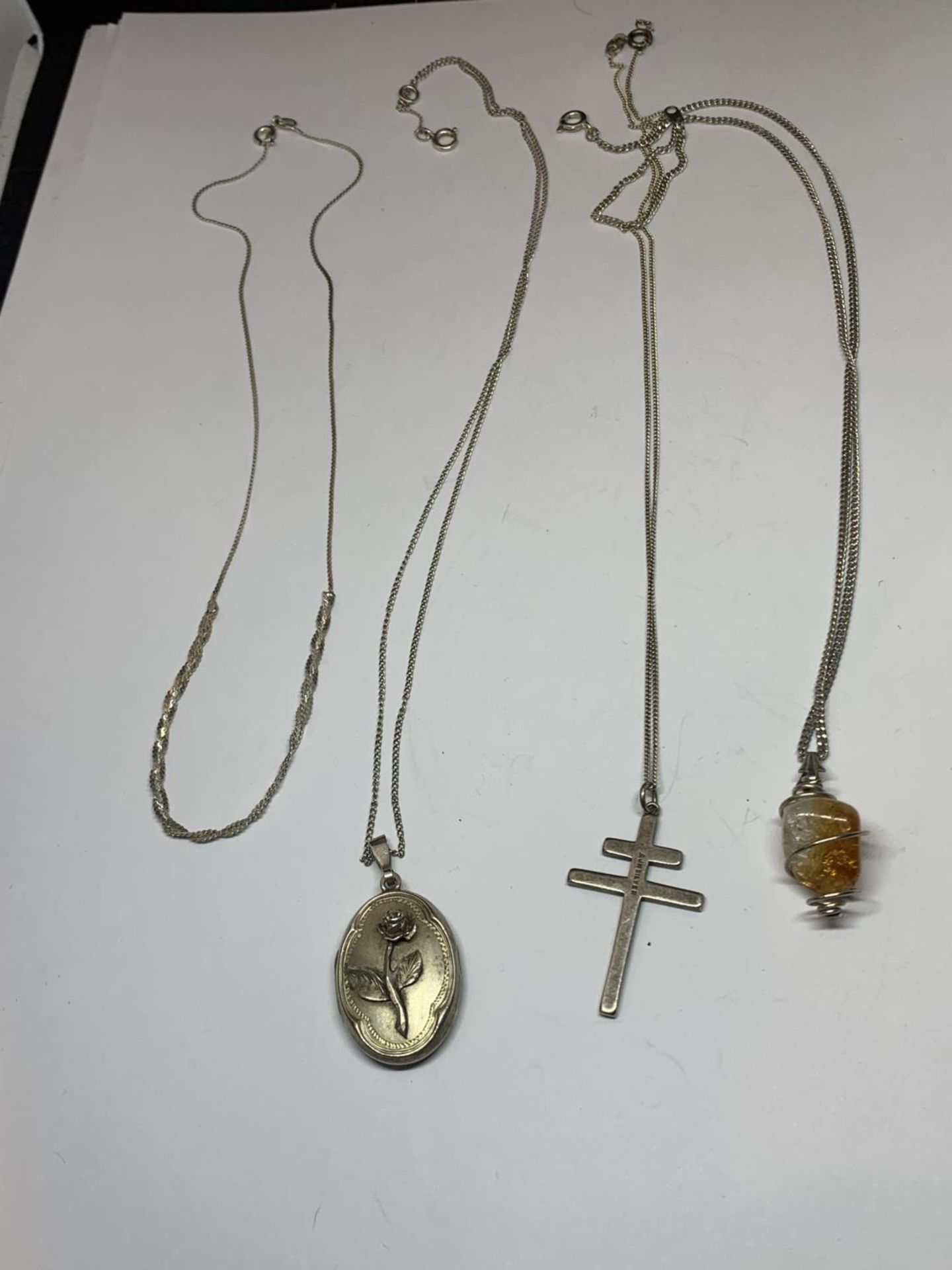 FOUR SILVER NECKLACES THREE WITH PENDANTS
