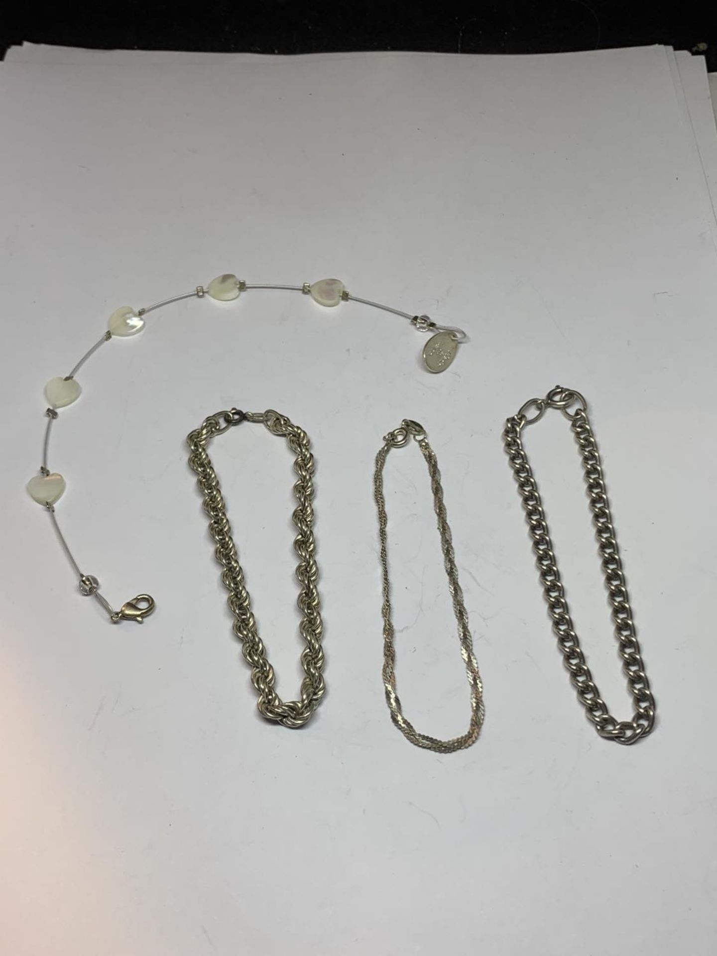 FOUR VARIOUS SILVER BRACLETS