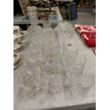 A LARGE QUANTITY OF GLASSWARE TO INCLUDE A DECANTER, BRANDY GLASSES, WINE GLASSES, TUMBLERS, ETC.,