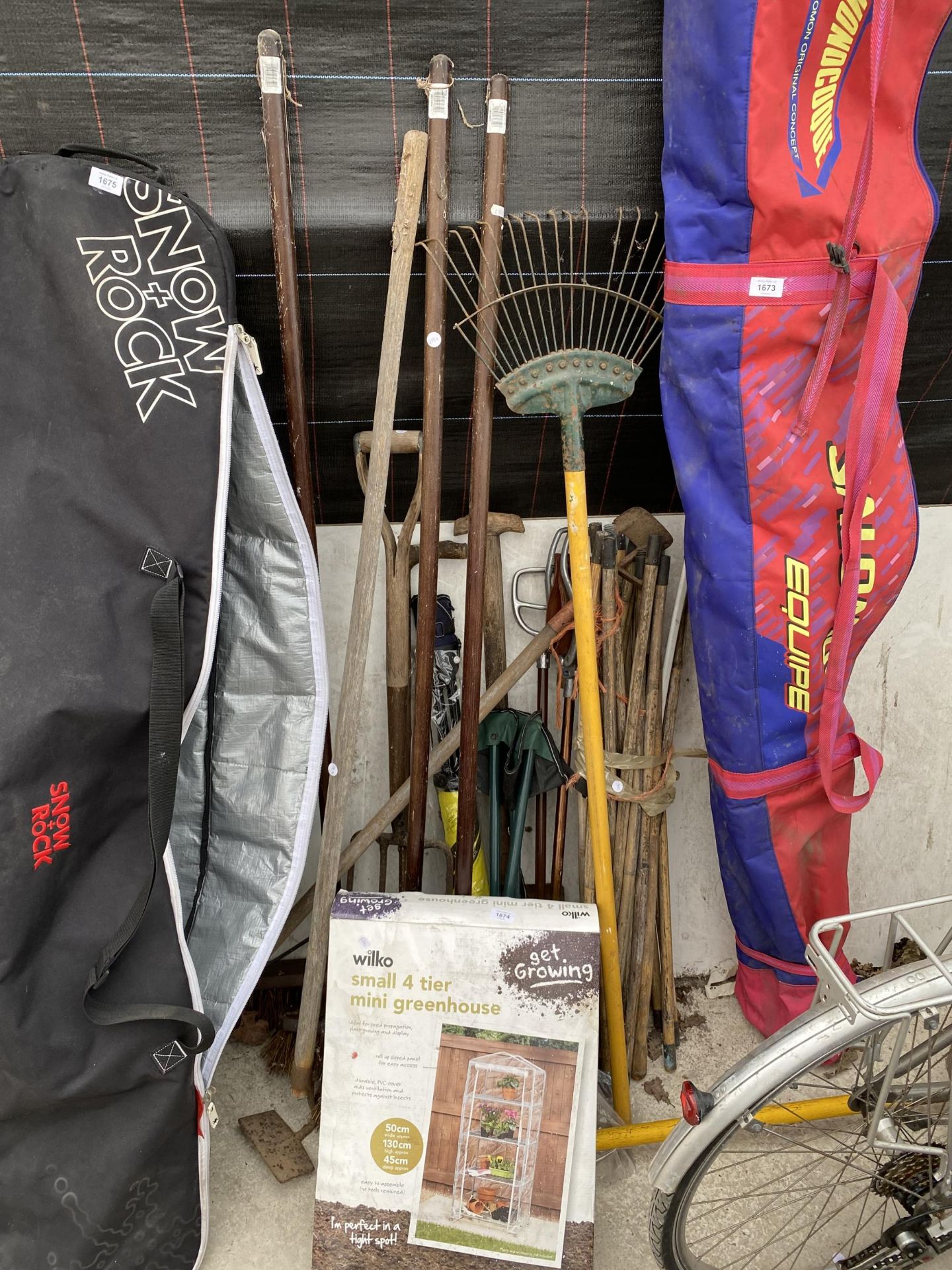 A LARGE ASSORTMENT OF GARDEN TOOLS TO INCLUDE DRAINING RODS, RAKES AND FORKS ETC