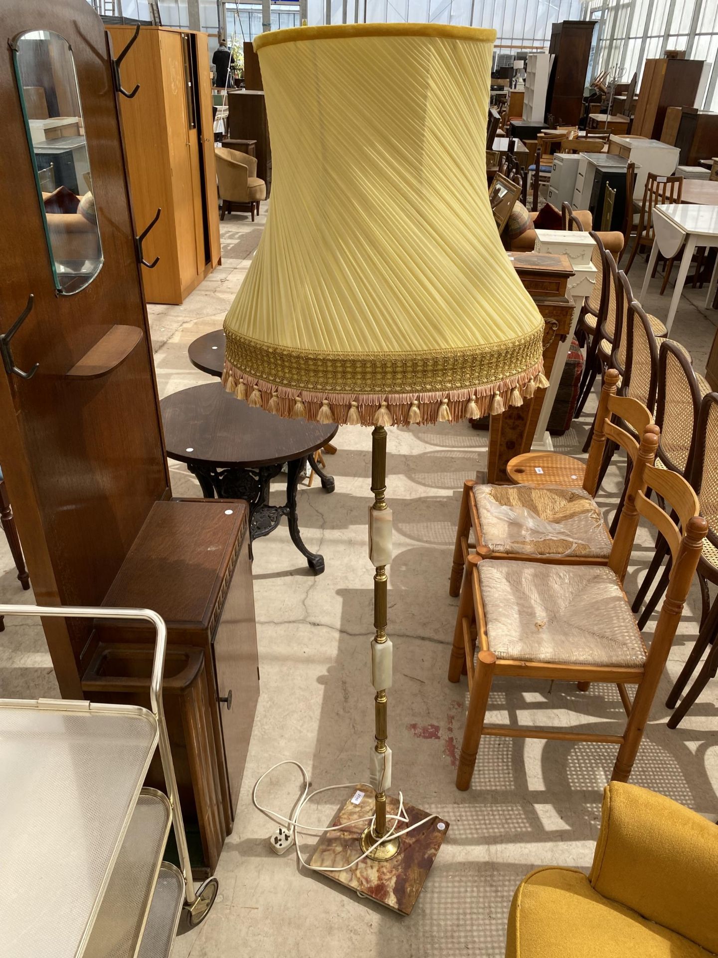 A 20TH CENTURY ONYX AND BRASS STANDARD LAMP COMPLETE WITH SHADE