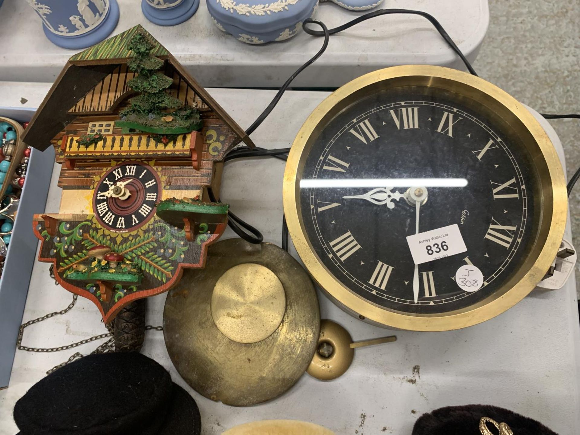 A VINTAGE HEAVY BRASS WALL CLOCK BY GIBSON PLUS A CUCKOO CLOCK IN NEED OF REPAIR