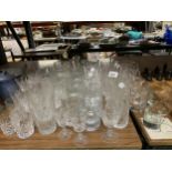 A LARGE QUANTITY OF GLASSES TO INCLUDE TUMBLERS, WINE, SHERRY, DESSERT BOWLS, WINE POURERS, ETC