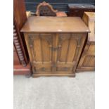 AN ANTIQUE STYLE OAK TV CABINET, 31" WIDE