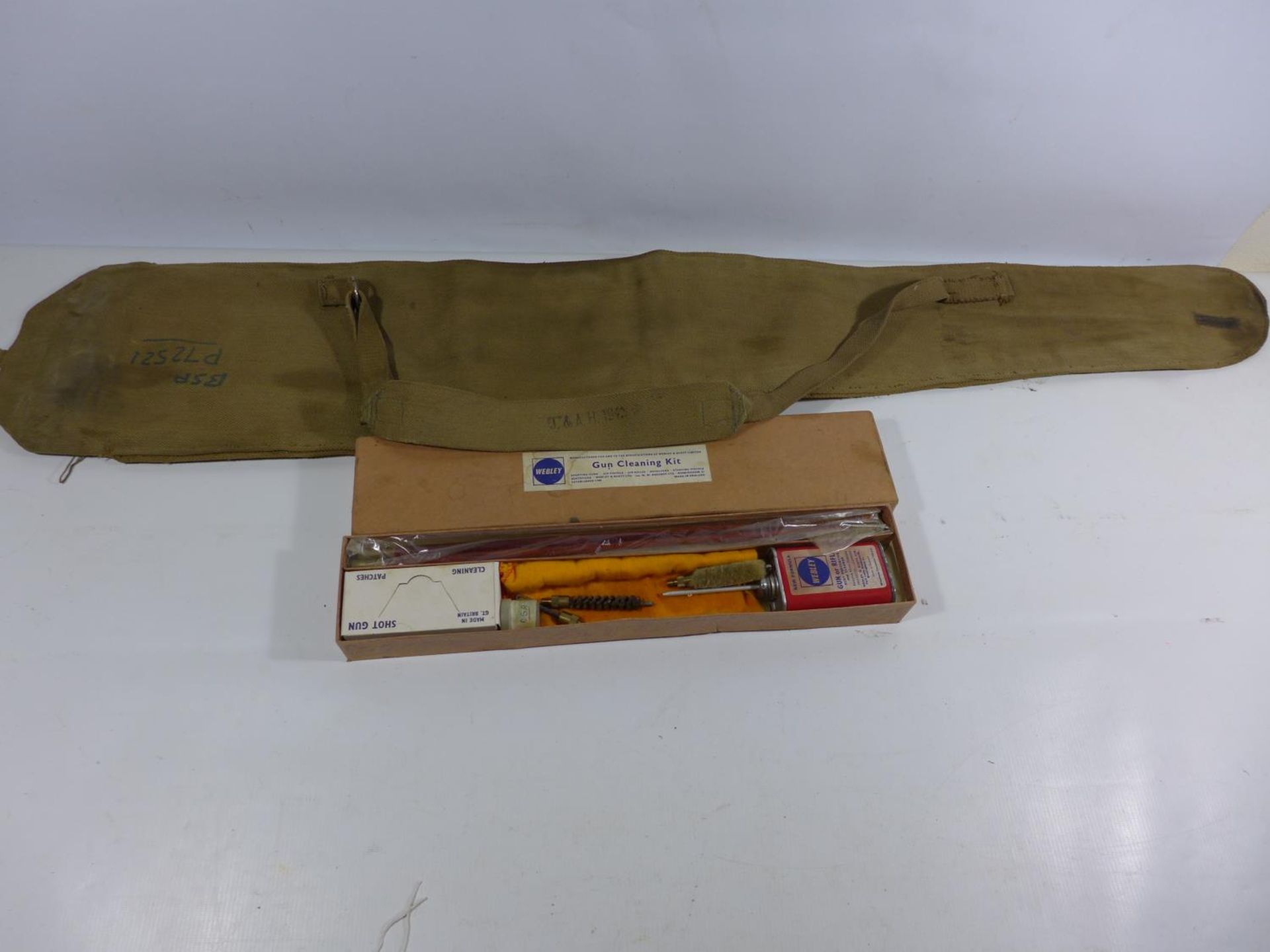 A CANVAS SLIP CASE FOR A 1942 MARK III SNIPERS RIFLE AND A WEBLEY UNUSED GUN CLEANING KIT (2)