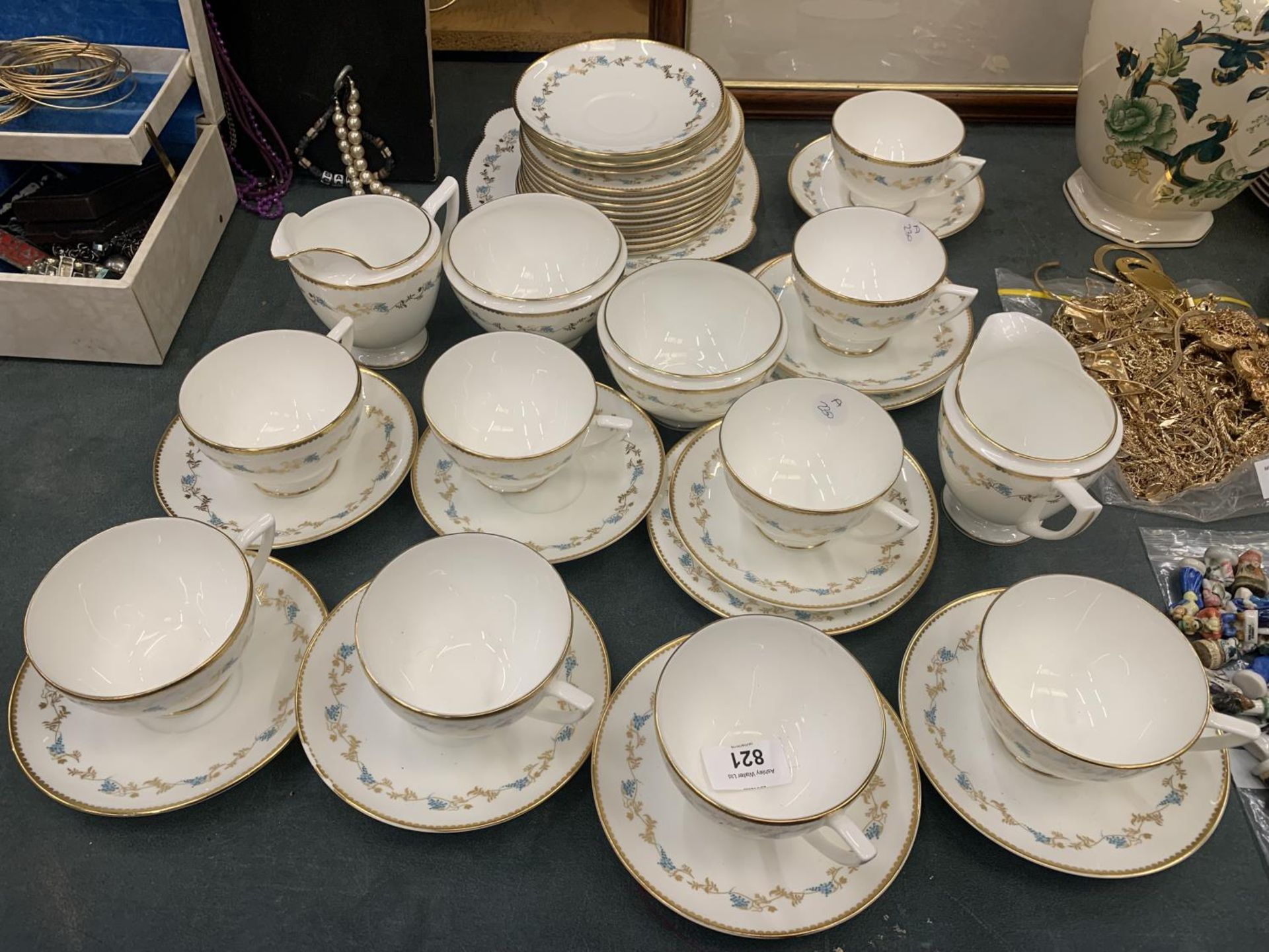 A MINTON 'CHAMPAGNE' TEASET TO INCLUDE A CAKE PLATE, CUPS, SAUCERS, SIDE PLATES, TWO CREAM JUGS