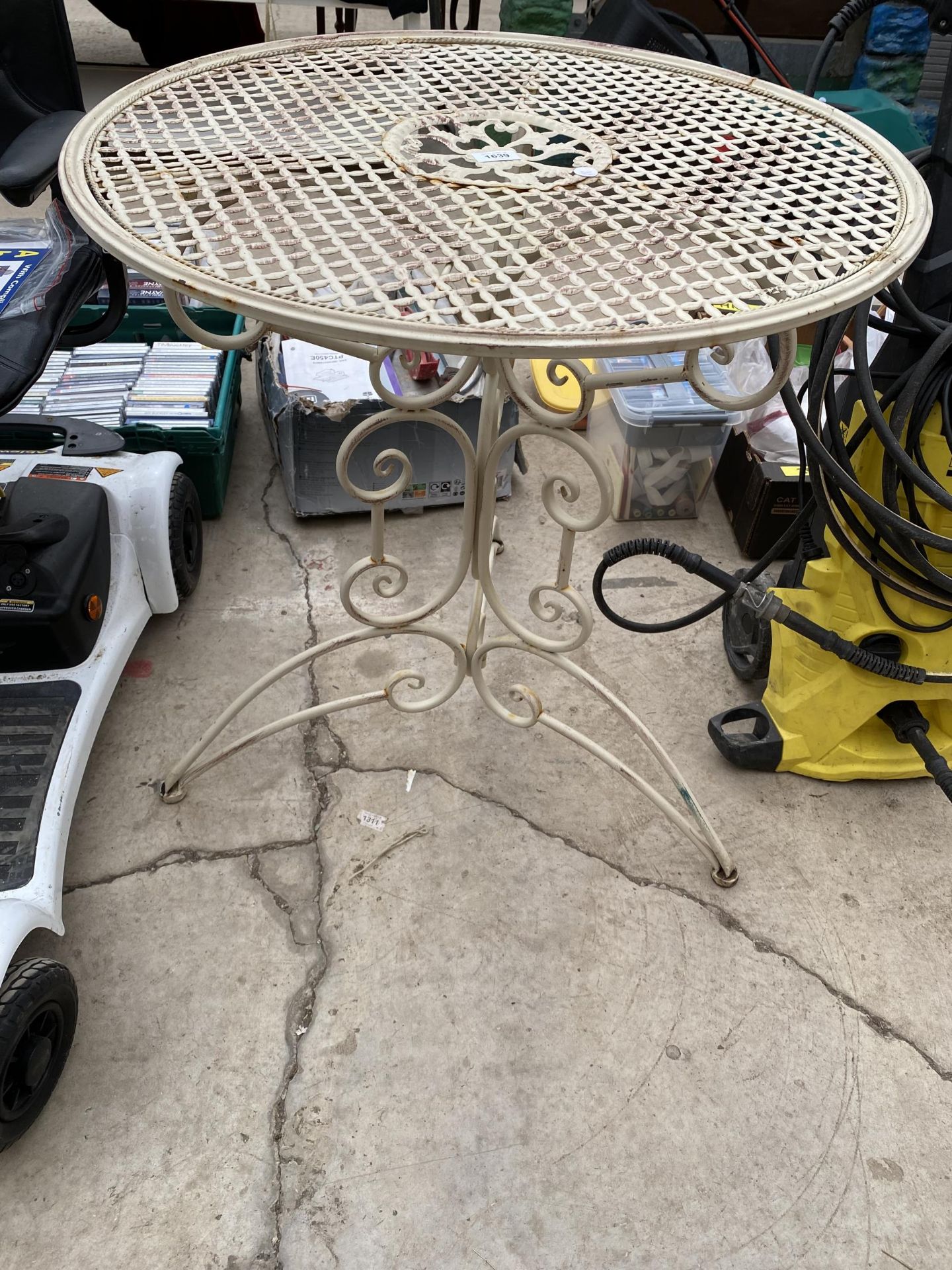 A DECORATIVE METAL BISTRO TABLE