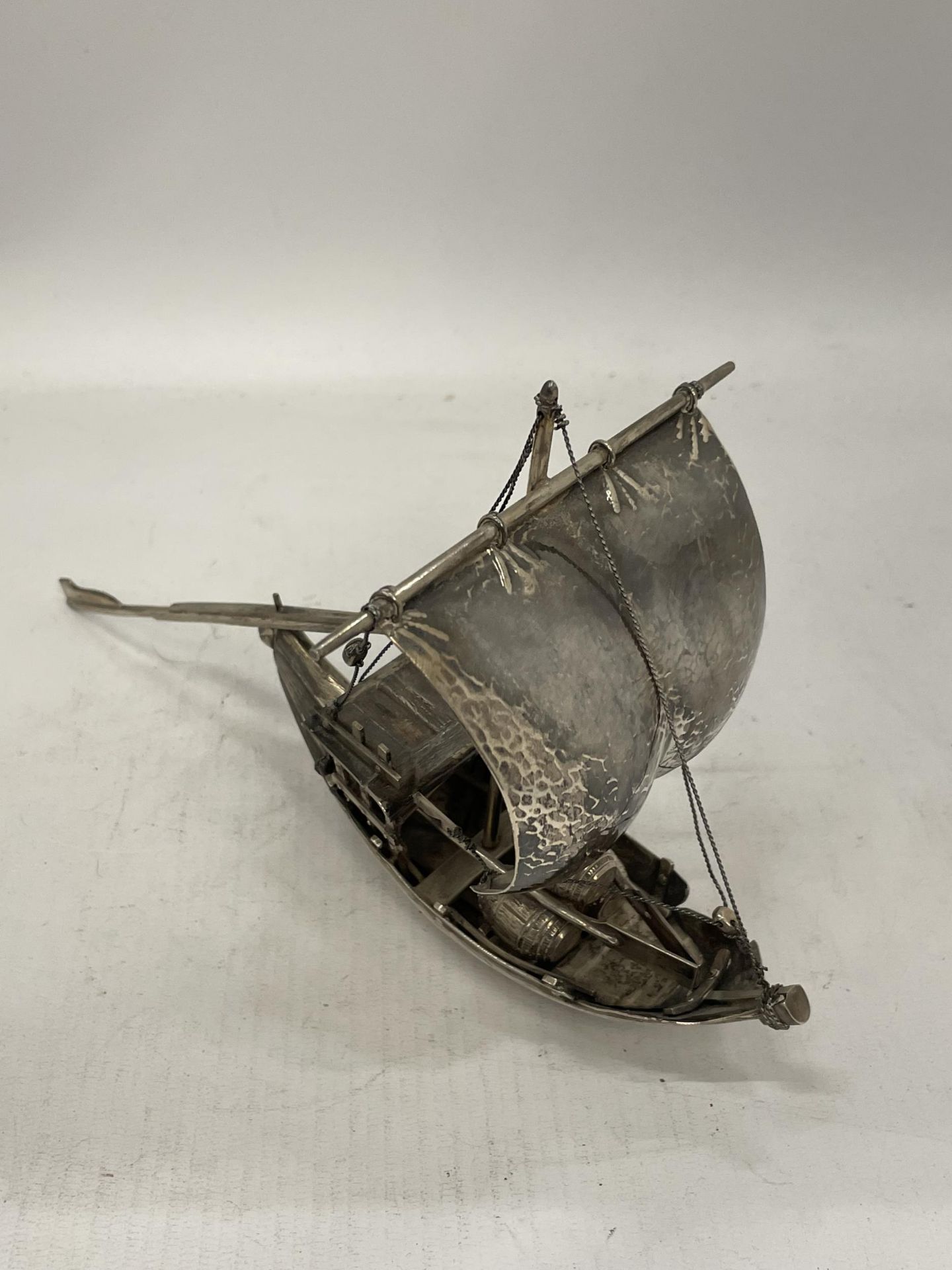 A VINTAGE MIDDLE EASTERN, POSSIBLY SILVER, CARGO BOAT MODEL, LENGTH 22CM, WEIGHT 353G