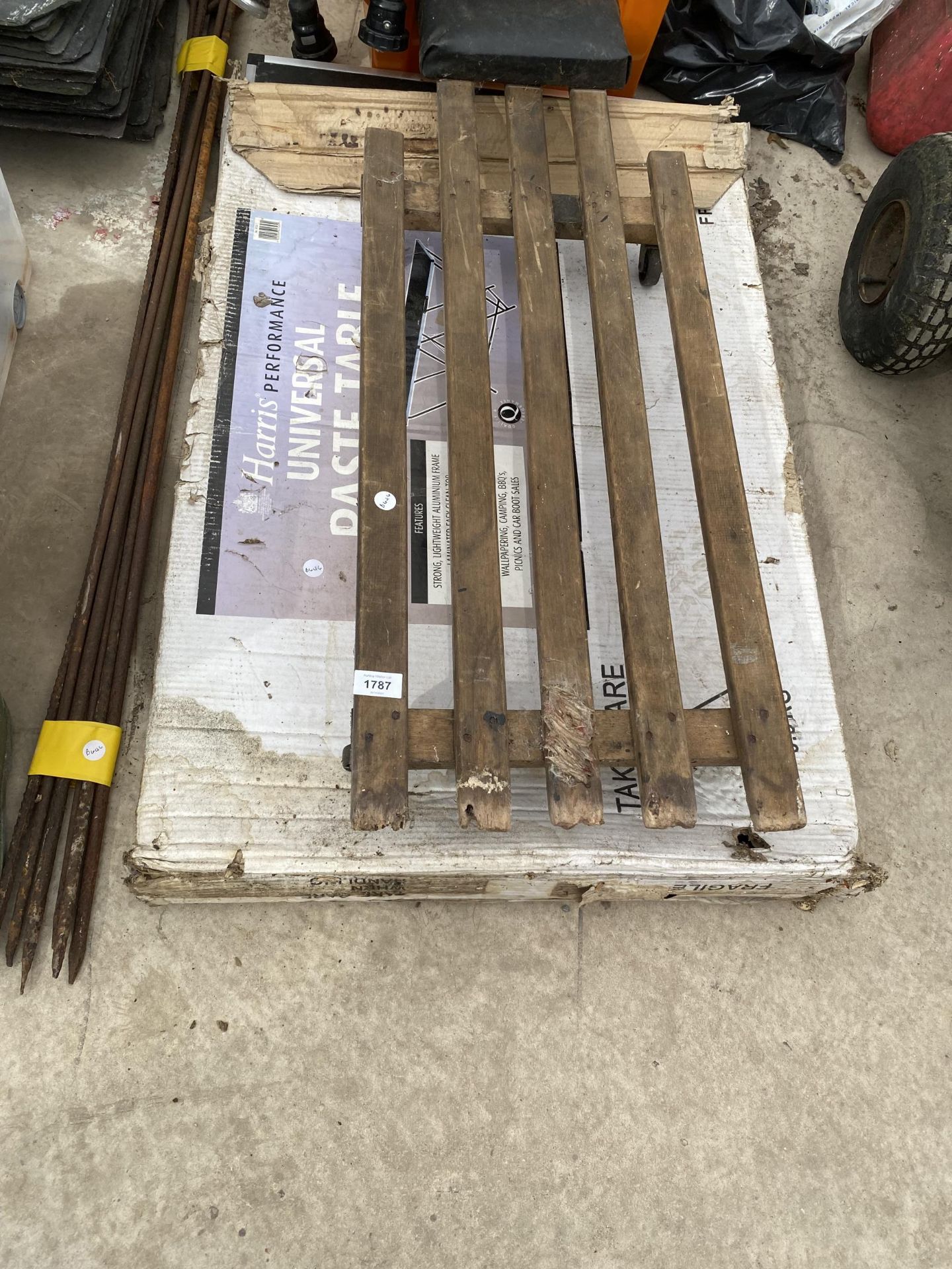 A QUANTITY OF ROAD STAKES, A MECHANICS TROLLEY AND A PASTING TABLE