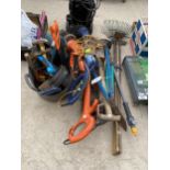 A LARGE QUANTITY OF GARDEN TOOLS TO INCLUDE ELECTRIC STRIMMERS, RAKES AND SHEARS ETC