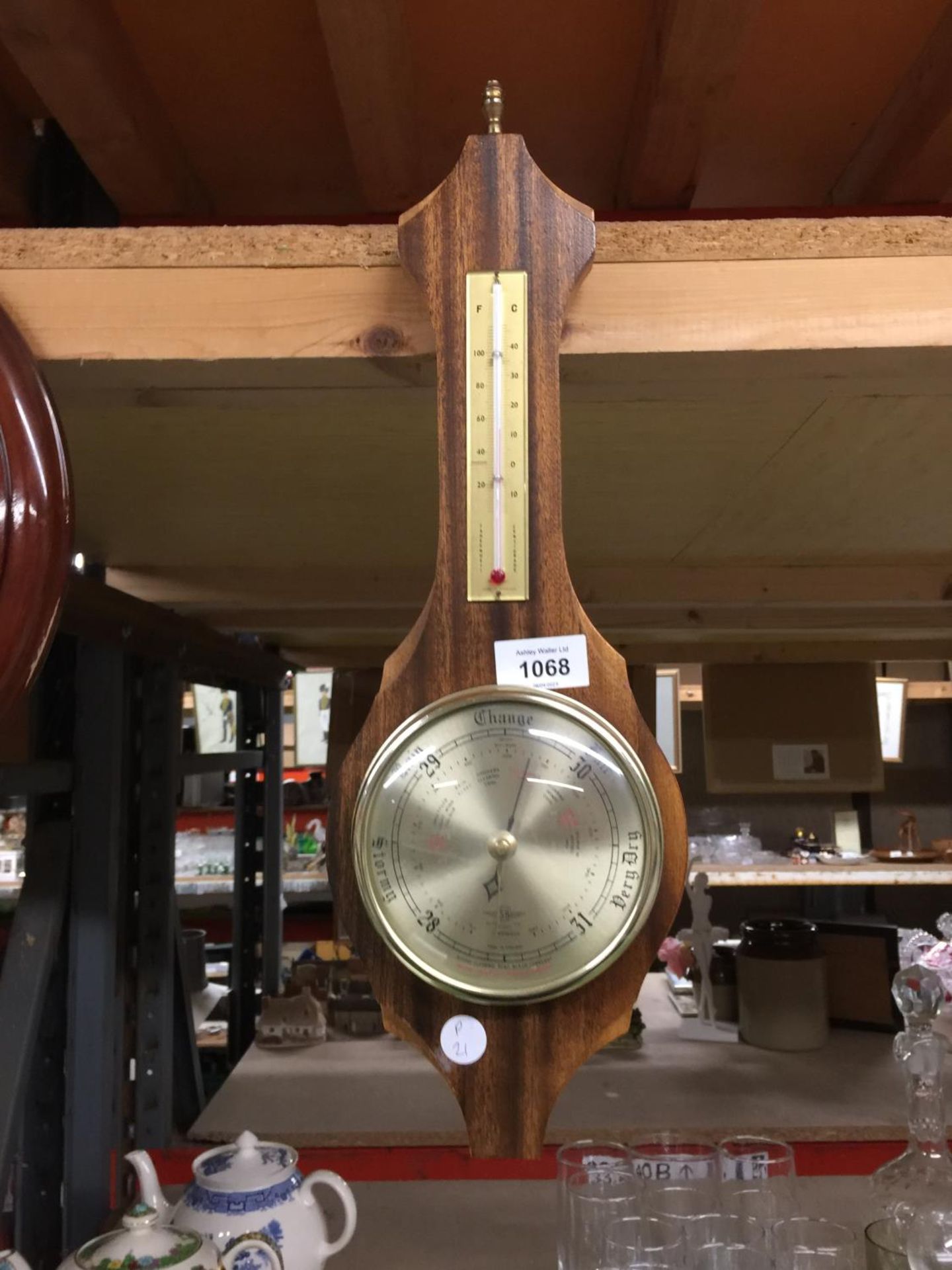 A BAROMETER IN A WOODEN FRAME