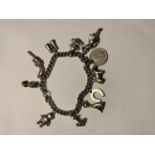 A SILVER CHARM BRACELET WITH ELEVEN VARIOUS CHARMS