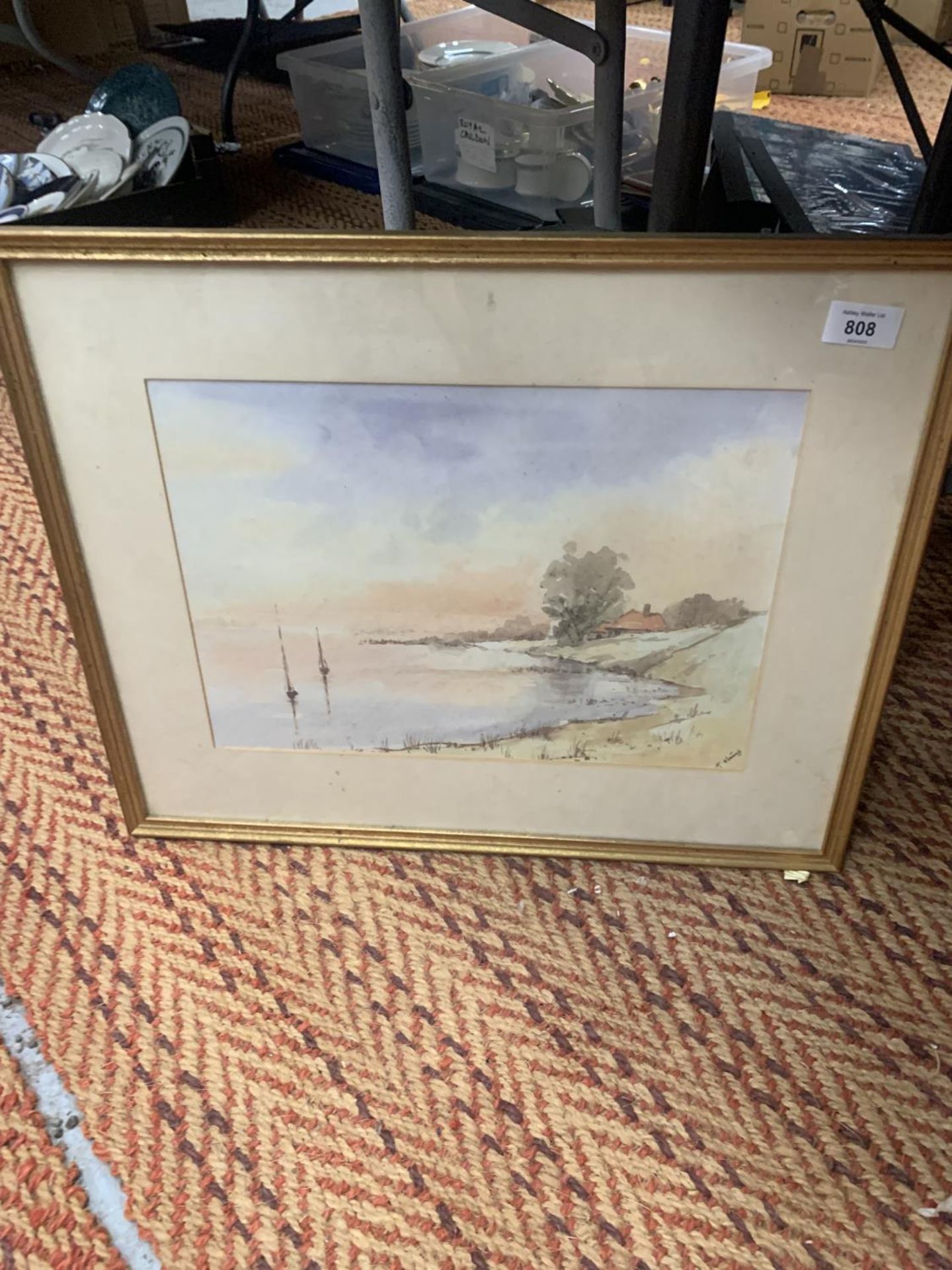 A FRAMED WATERCOLOUR OF A LAKE SCENE WITH INDISTINCT SIGNATURE 54CM X 43CM