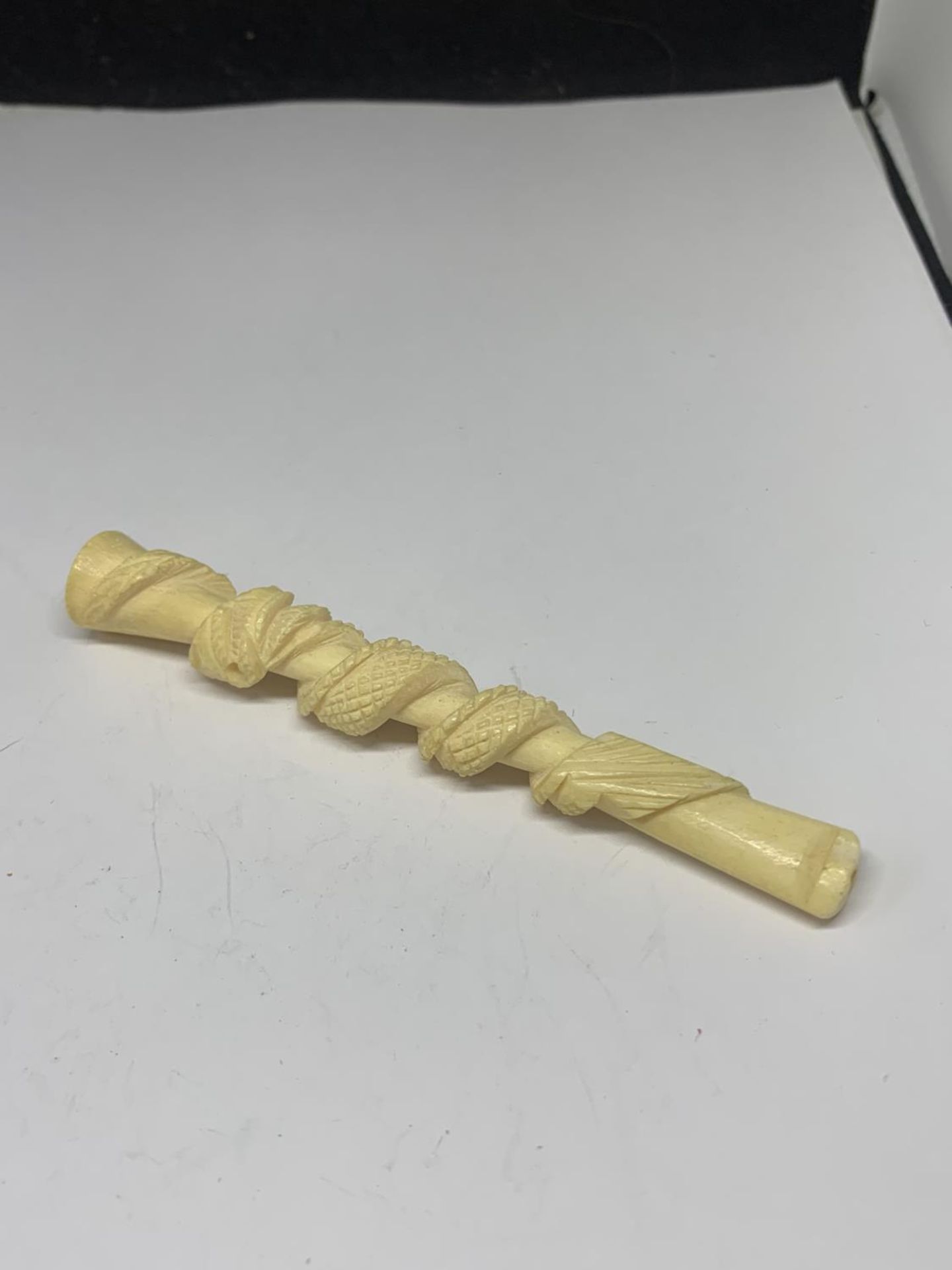 A CARVED BONE CHEROOT HOLDER