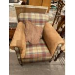 A LIGHT TAN AND TARTAN EASY CHAIR ON TAPERING LEGS