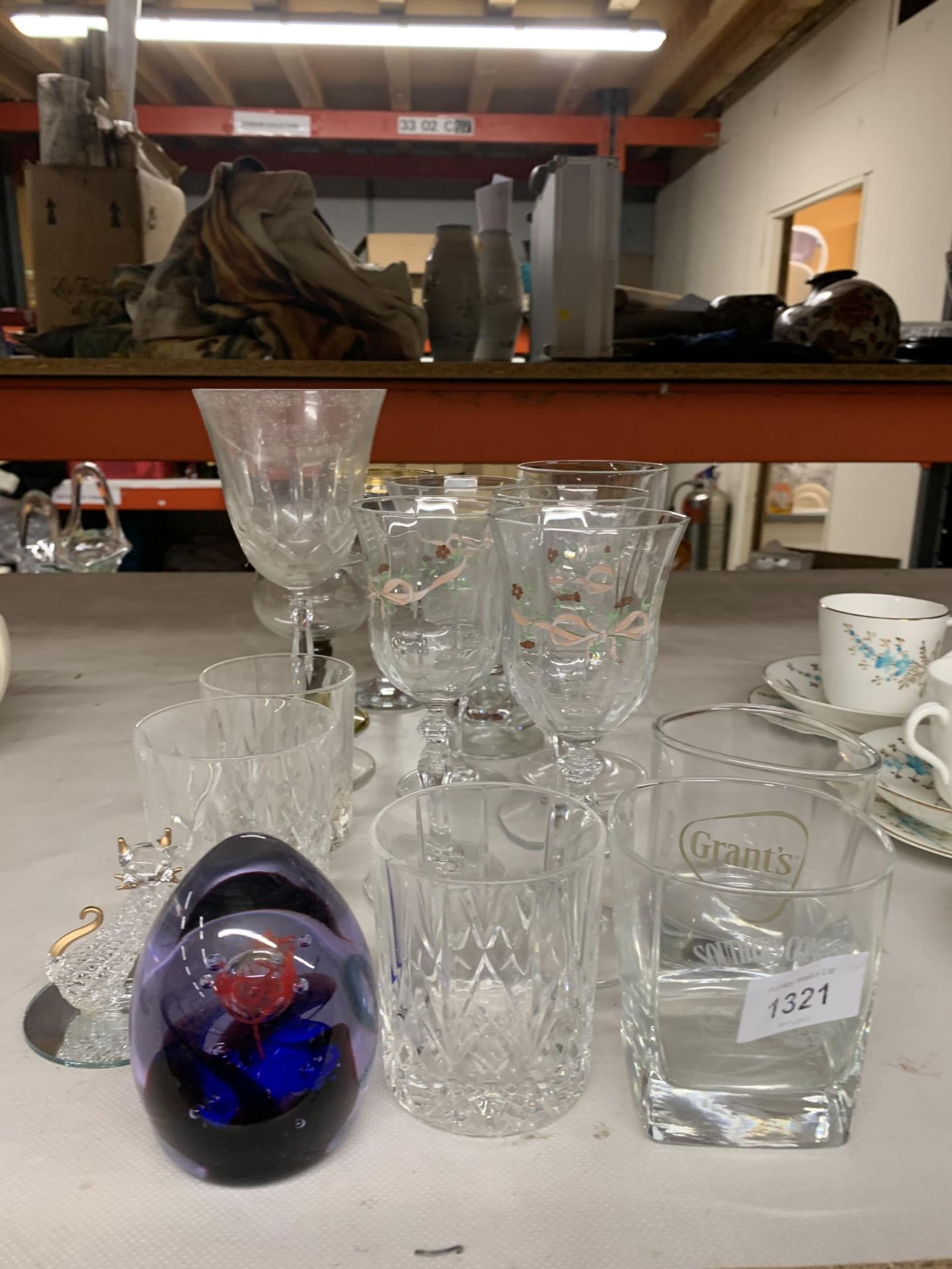 A QUANTITY OF GLASSES TO INCLUDE WINE, TUMBLERS, A PAPERWEIGHT, A CAT, ETC