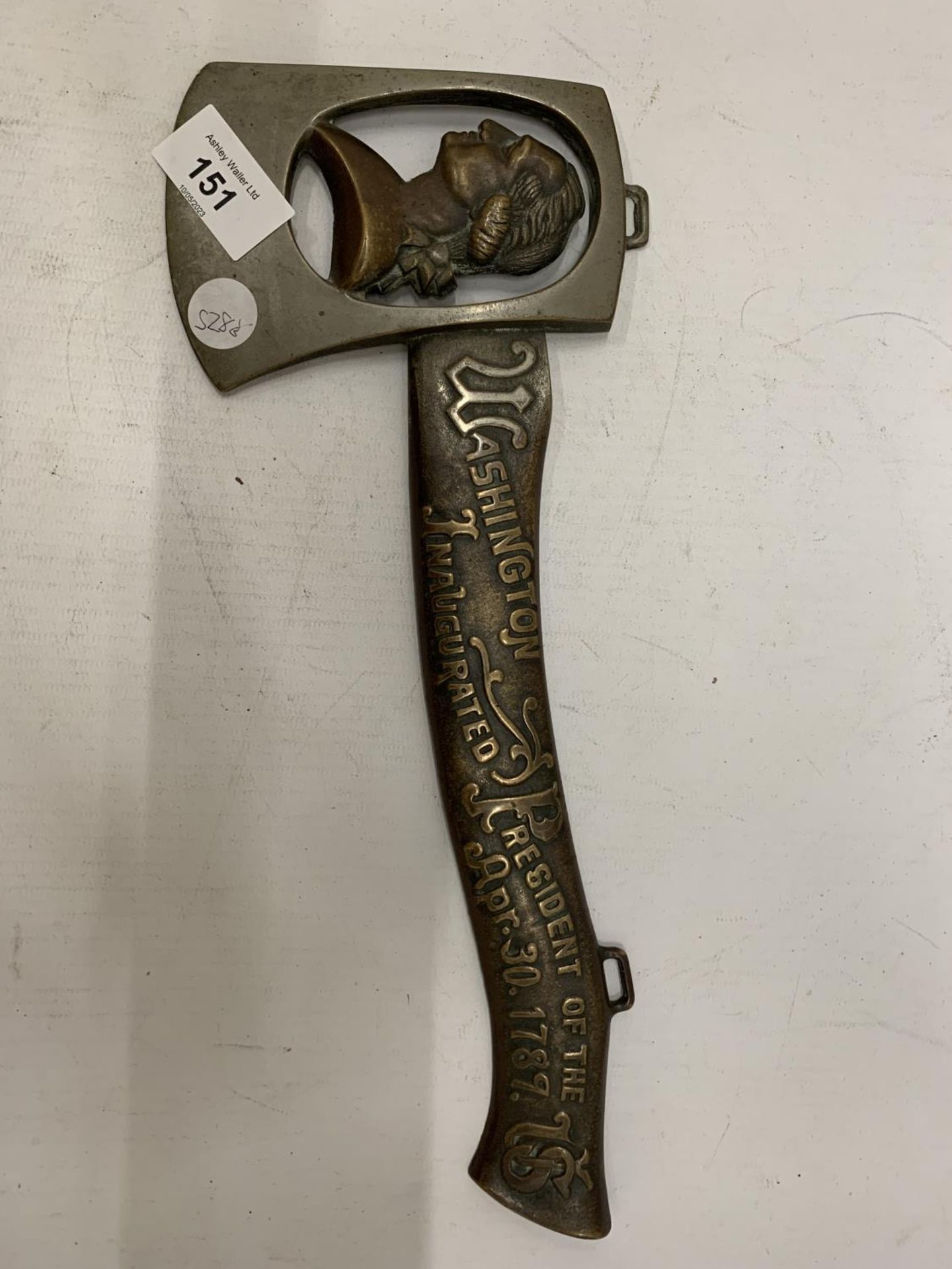 A METAL AXE WITH AN IMAGE OF GEORGE WASHINGTON, INSCRIBED 'WASHINGTON INAUGURATED PRESIDENT OF THE