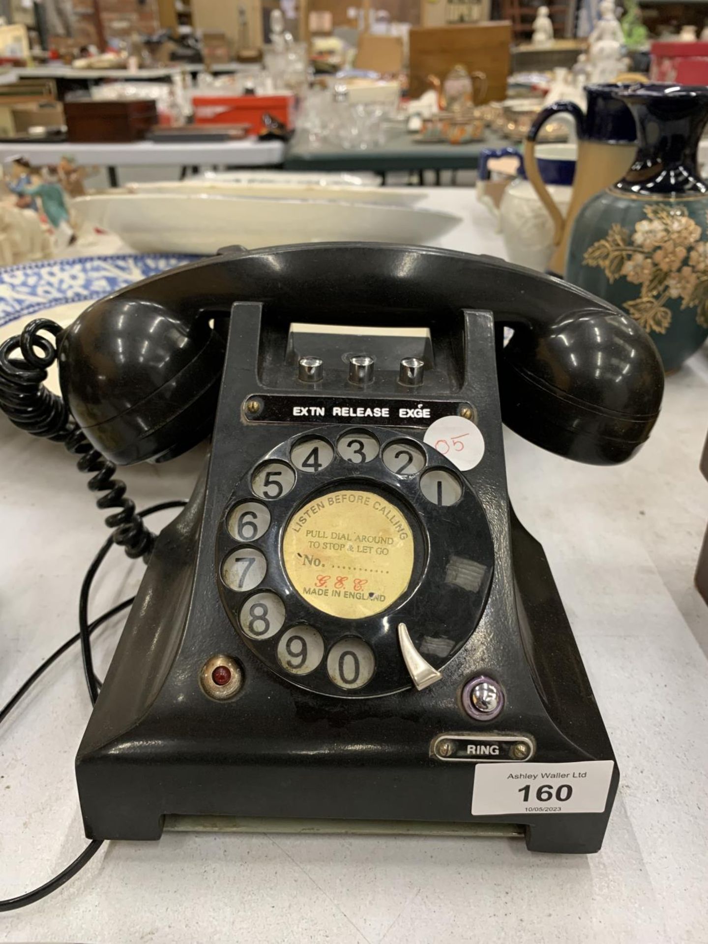 A VINTAGE BLACK BAKELITE ROTARY DIAL TELEPHONE