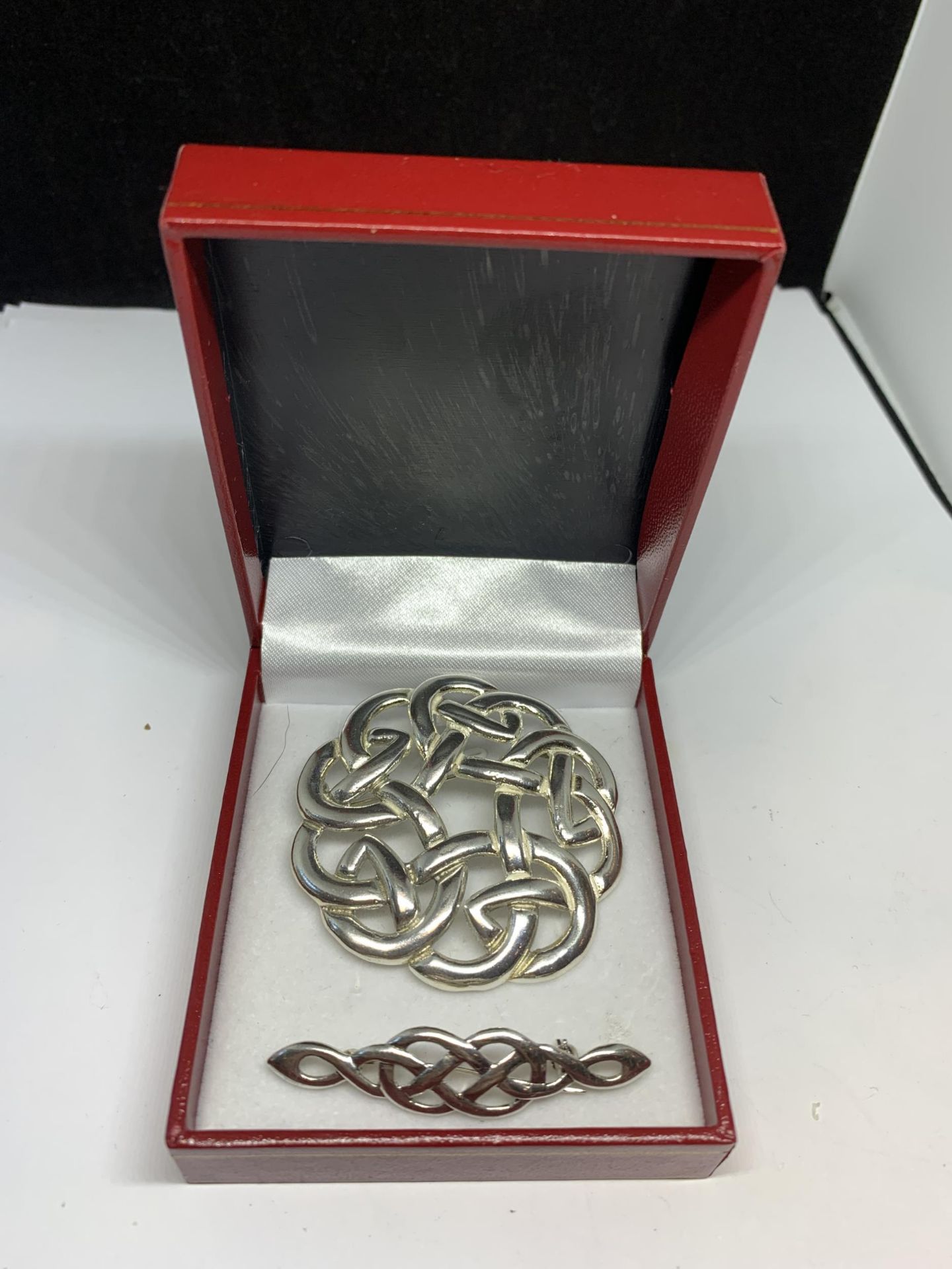 TWO MARKED SILVER CELTIC STYLE BROOCHES IN A PRESENTATION BOX