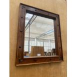 A DECORATIVE WOODEN FRAMED WALL MIRROR