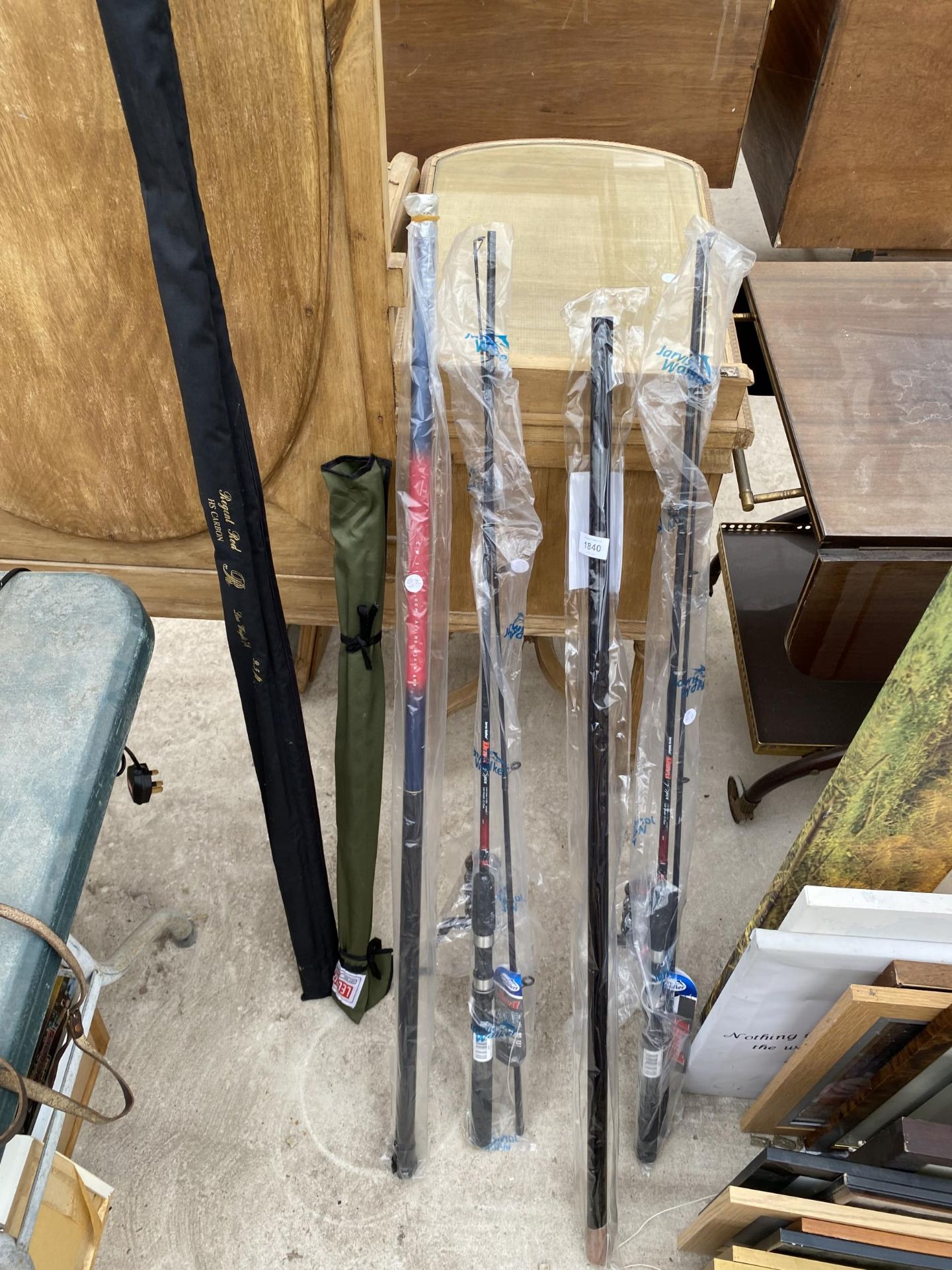 AN ASSORTMENT OF FISHING RODS TO INCLUDE SOME WITH REELS