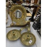 A BRASS MIRROR WITH EMBOSSED FRAME DIAMETER 31CM, TWO VINTAGE CANDLE HOLDERS WITH DECORATION AND