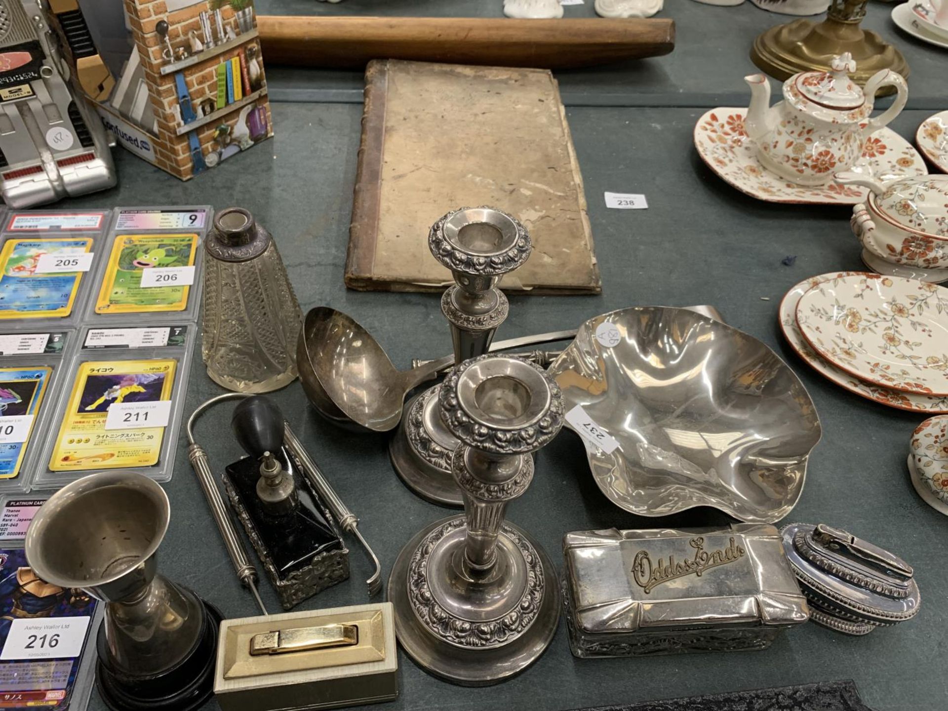 A QUANTITY OF SILVER PLATED ITEMS TO INCLUDE CANDLESTICKS, TABLE LIGHTERS, A LADEL, PERFUME