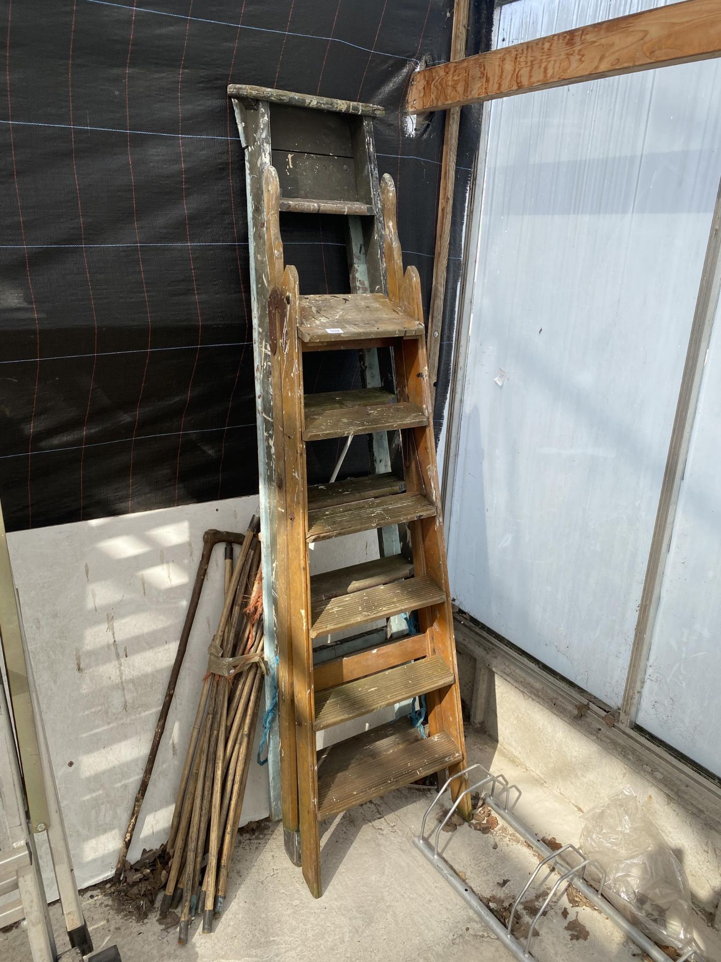 TWO VINTAGE WOODEN LADDERS AND A SET OF DRAINING RODS