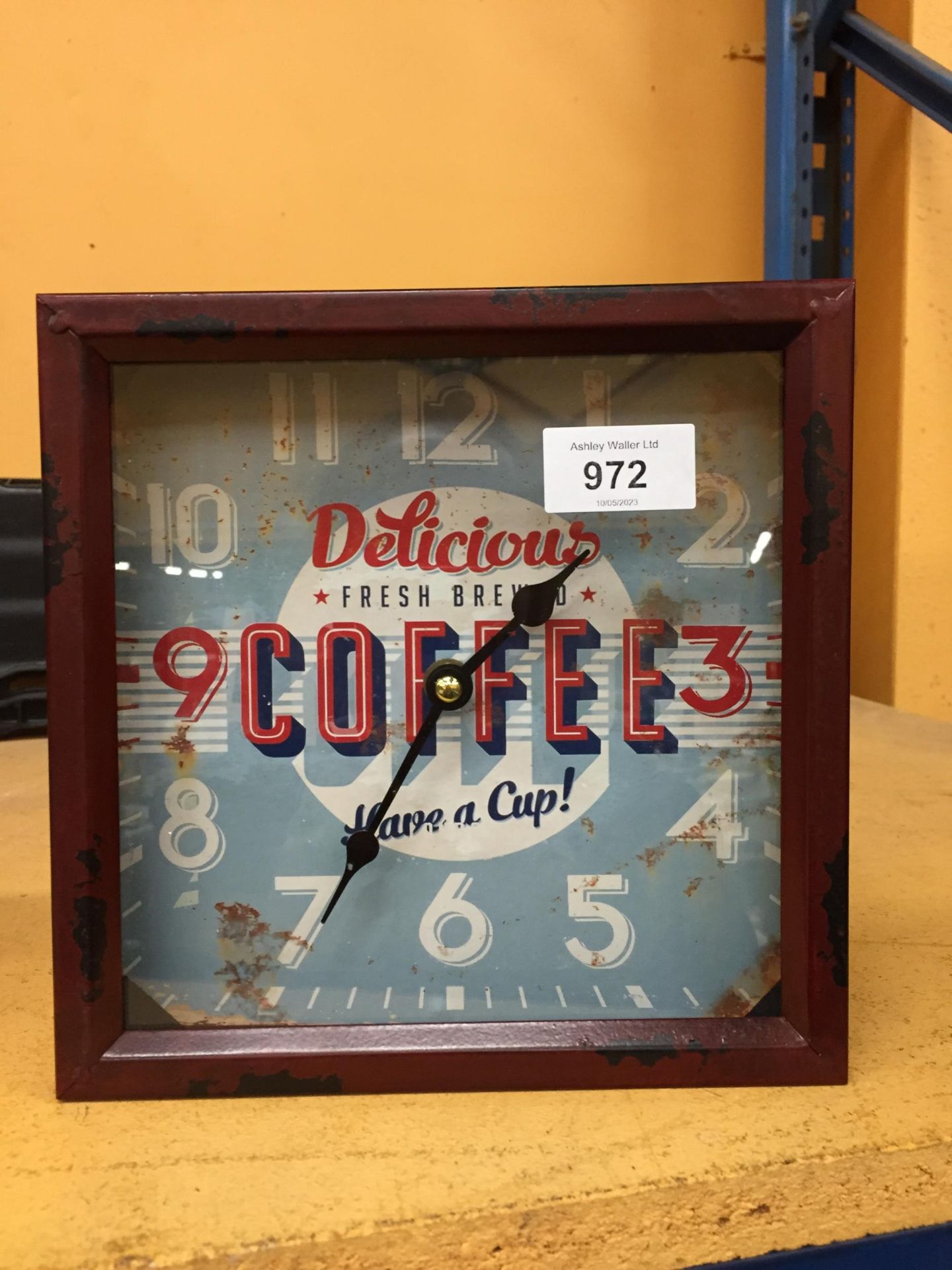 A TIN FRAMED COFFEE DESIGN CLOCK