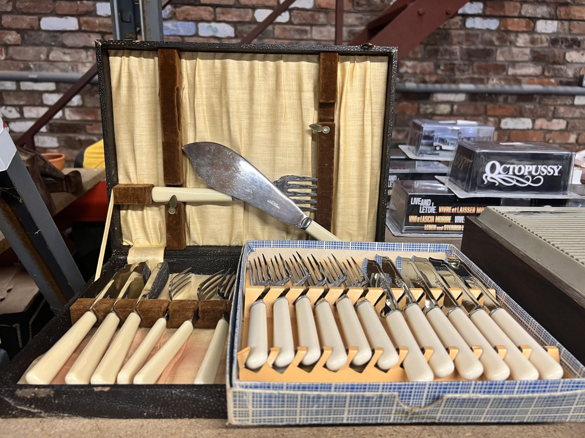 A VINTAGE BOXED CANTEEN OF CUTLERY PLUS A BOXED KNIFE AND FORK SET