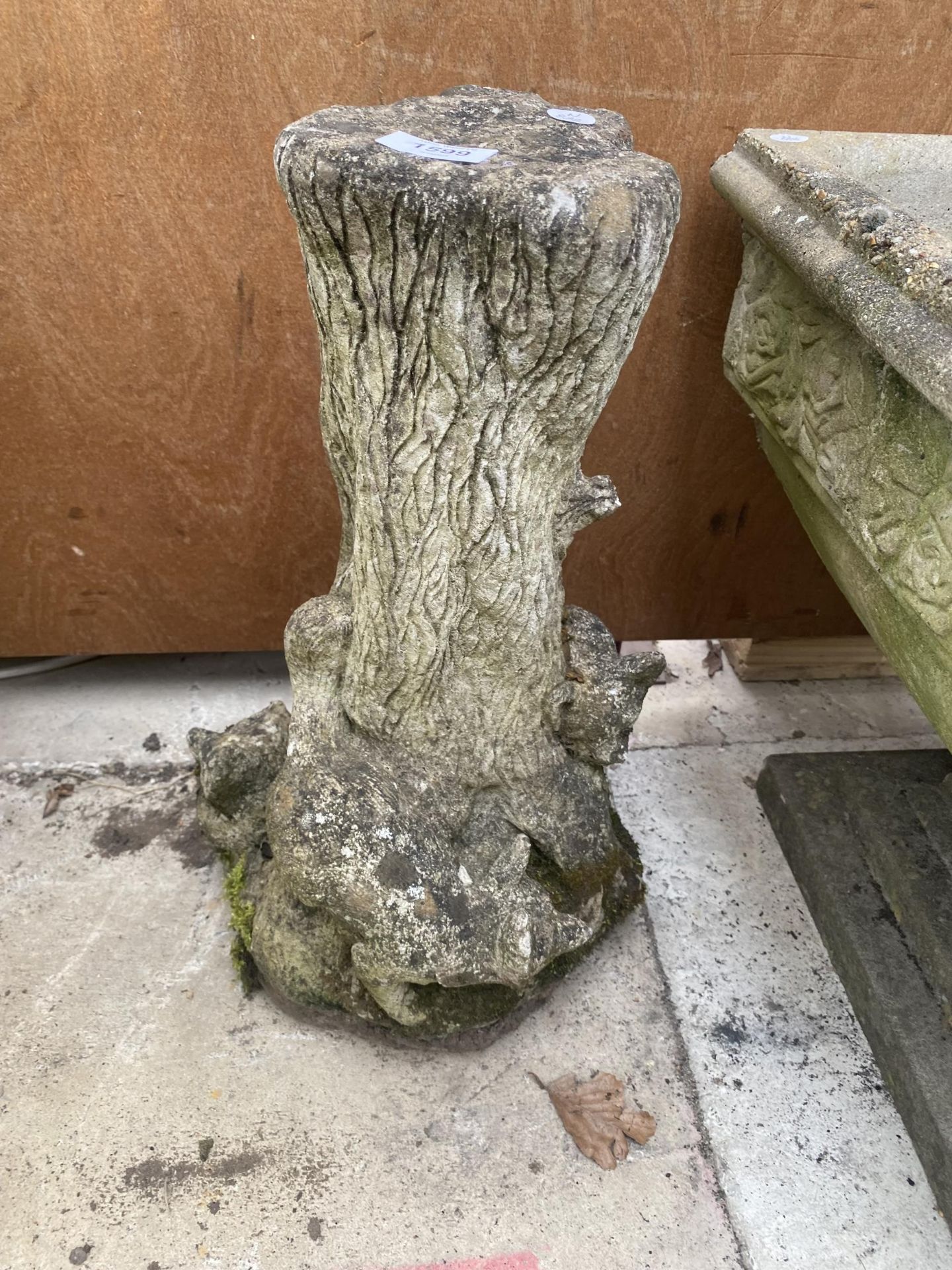 A RECONSTITUTED STONE PEDESTAL BASE WITH FOX DECORATION