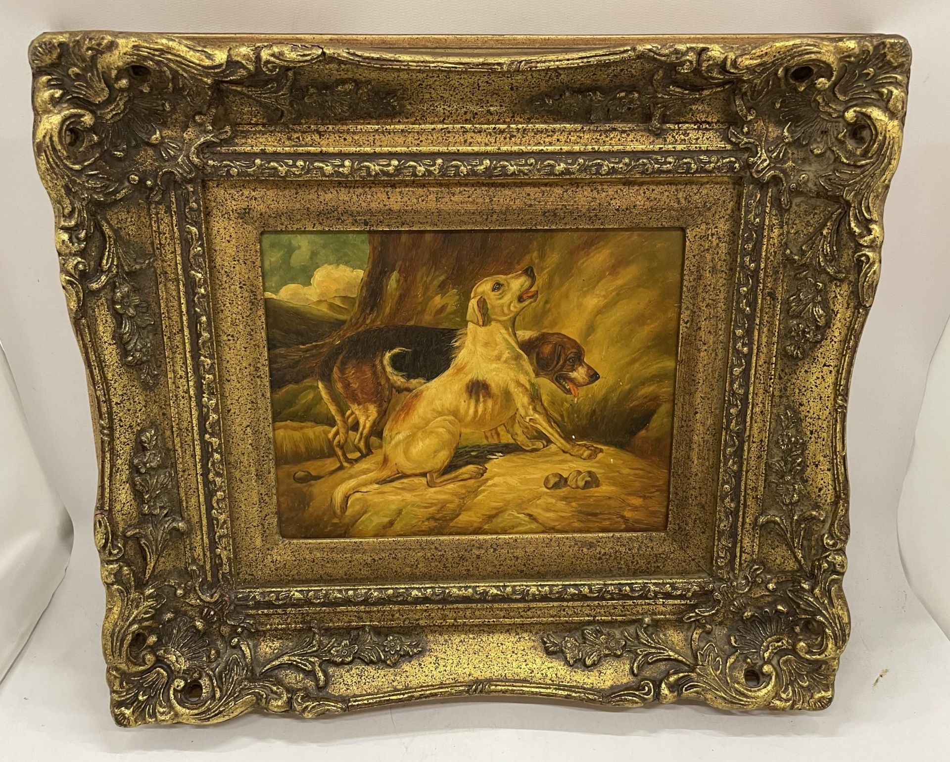 A VICTORIAN GILT FRAMED OIL ON METAL OF TWO HUNTING DOGS, FRAMED BY BIGGS & SONS