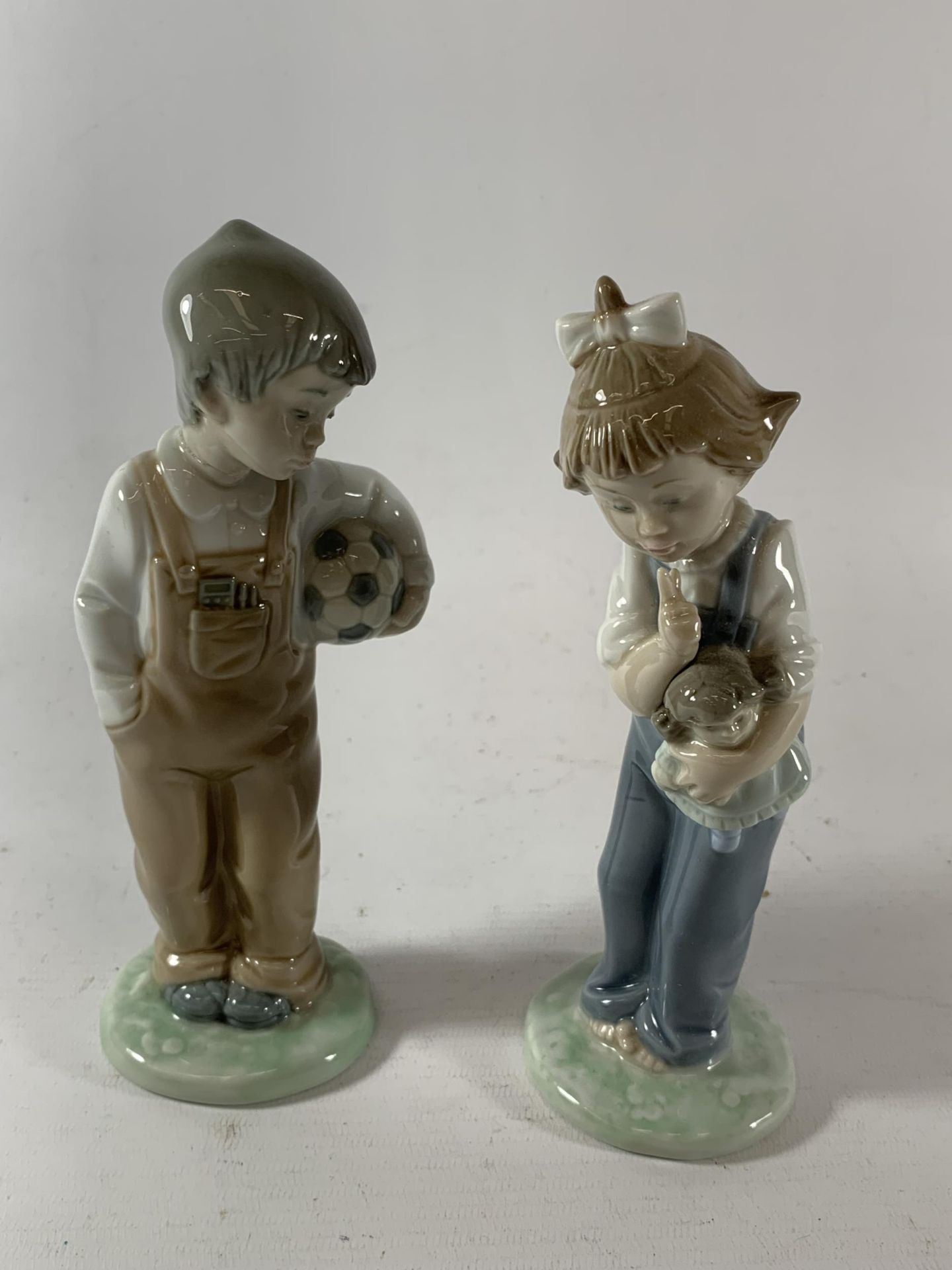TWO NAO BOY & GIRL FIGURES - ONE WITH A FOOTBALL