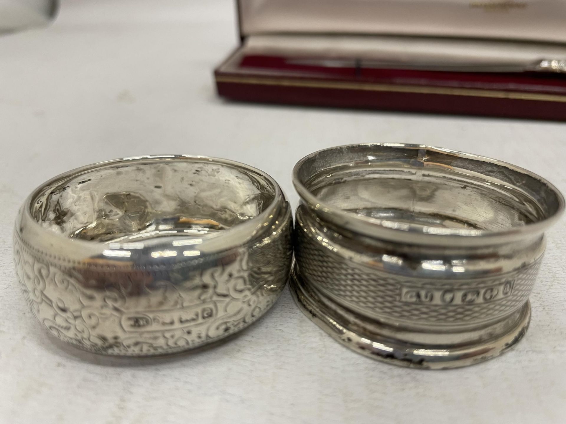 A CASED HALLMARKED SILVER HANDLED LETTER OPENER AND TWO HALLMARKED SILVER NAPKIN RINGS, TOTAL WEIGHT - Image 2 of 7