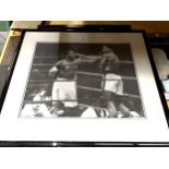 A SIGNED AND FRAMED BLACK AND WHITE PHOTOGRAPH OF MUHAMMED ALI AND JOE FRAZIER WITH CERTIFICATE