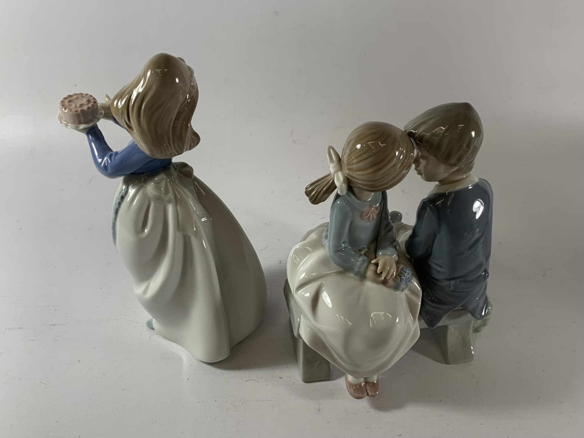 TWO NAO FIGURES - GIRL WITH CAKE AND CHILDREN ON A BENCH - Image 2 of 3