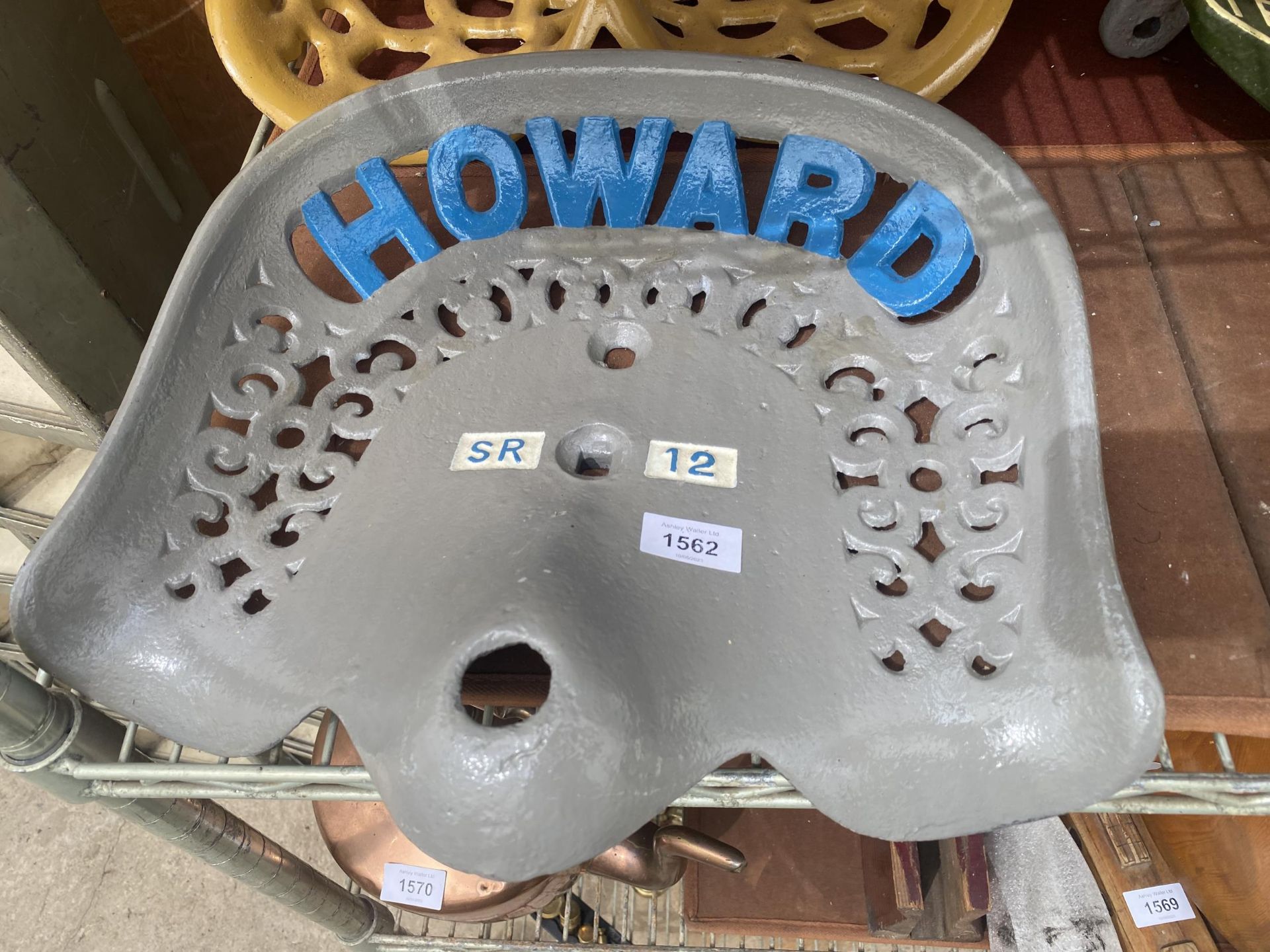 A VINTAGE PAINTED 'HOWARD' IMPLEMENT SEAT