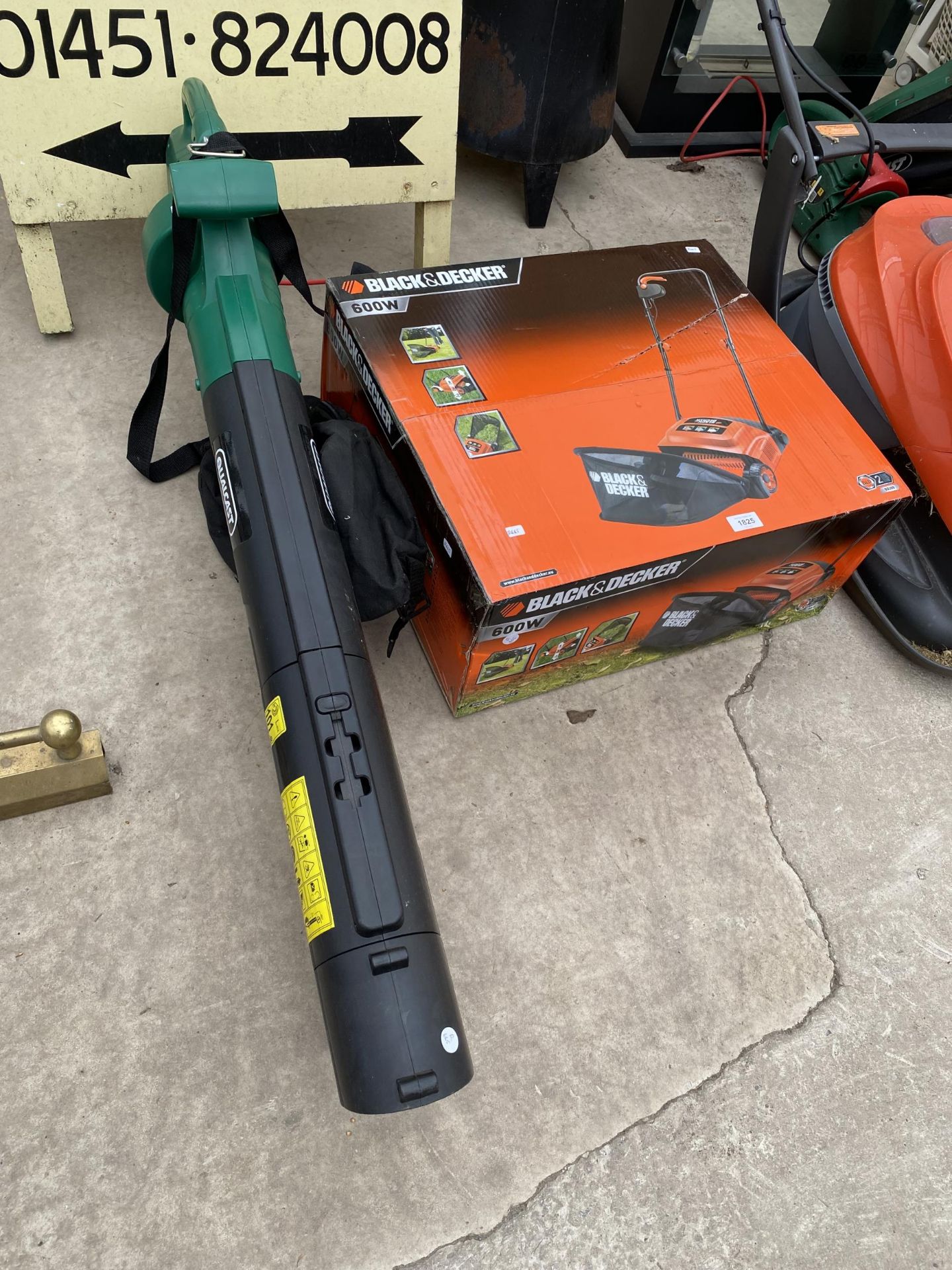 A BLACK AND DECKER ELECTRIC LAWN RAKE AND AN ELECTRIC QUALCAST LEAF VAC