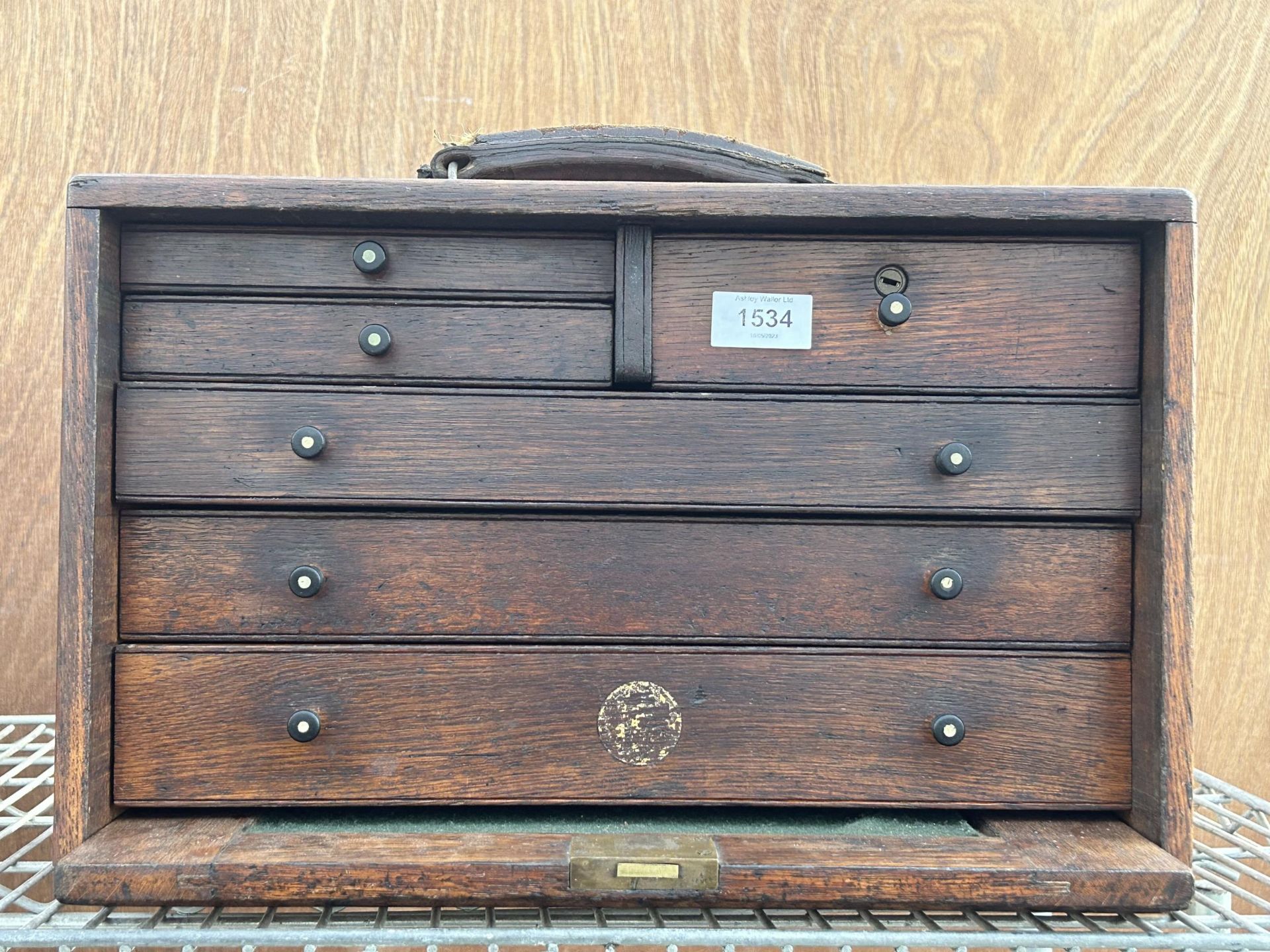 A VINTAGE MINIATURE OAK ENGINEERS CHEST WITH THREE LONG AND THREE SHORT DRAWERS AND A DROP DOWN