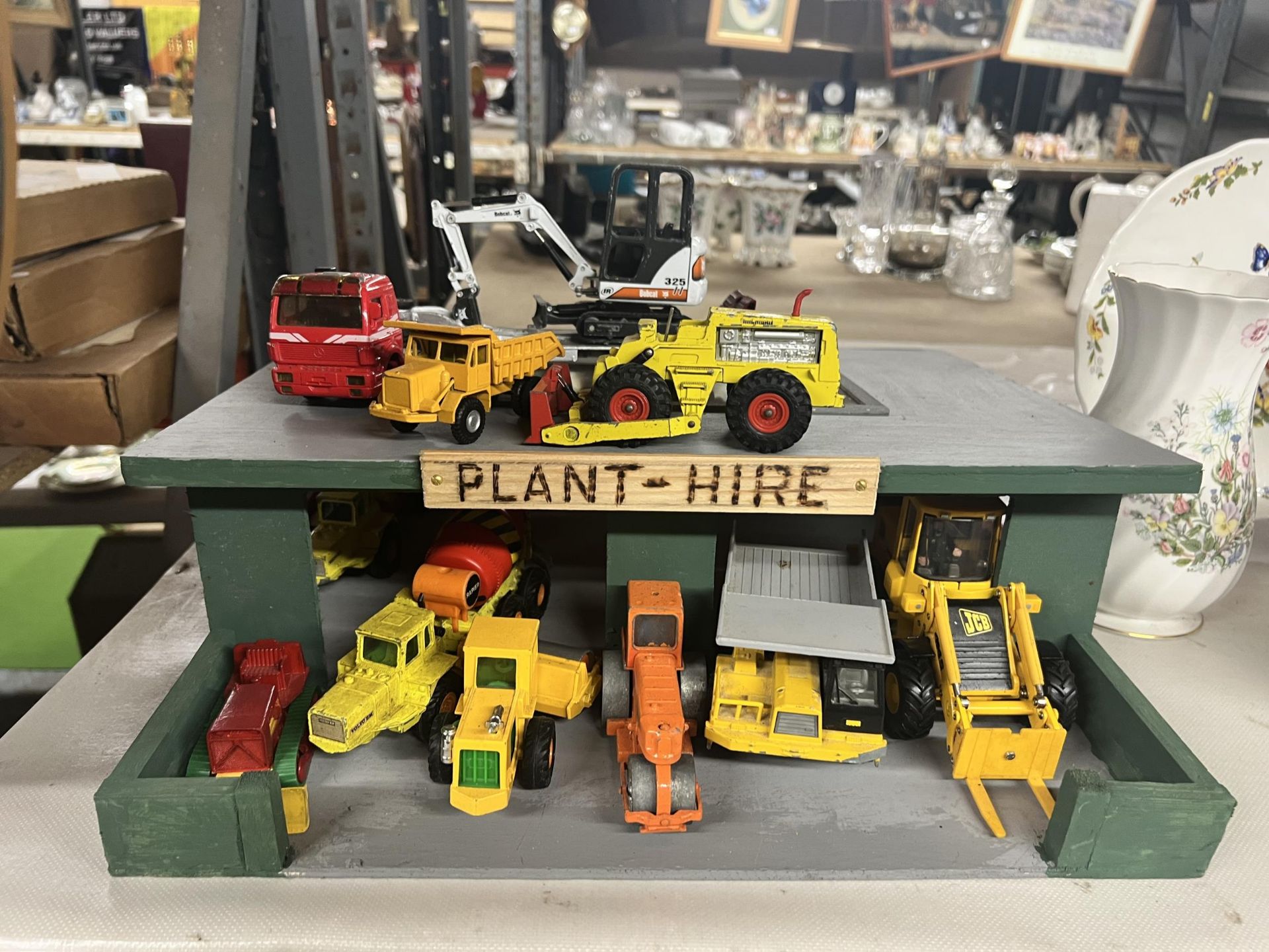 A PLANT HIRE GARAGE WITH TWELVE VARIOUS VEHICLES AND MACHINES