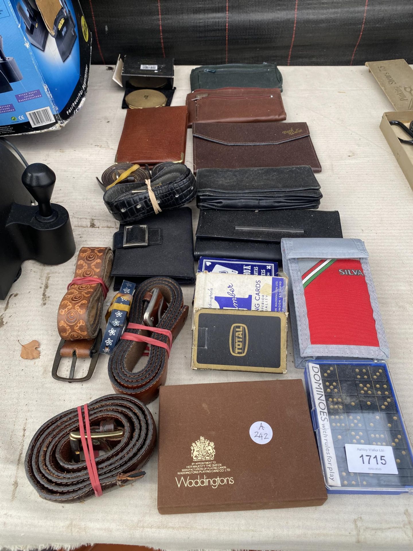 AN ASSORTMENT OF ITEMS TO INCLUDE WALLETS, BELTS AND PLAYING CARDS ETC