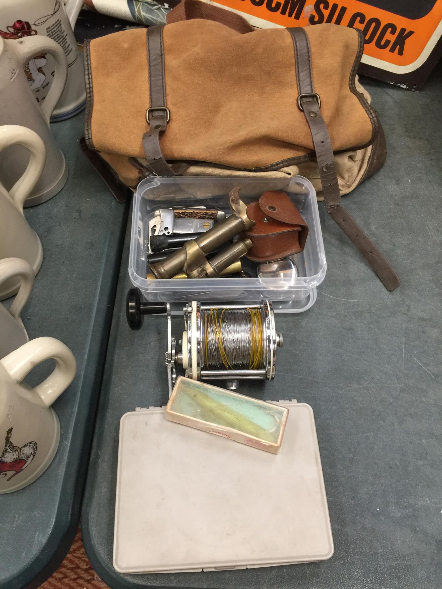 A FISHING BAG, REEL, PENKNIVES ETC