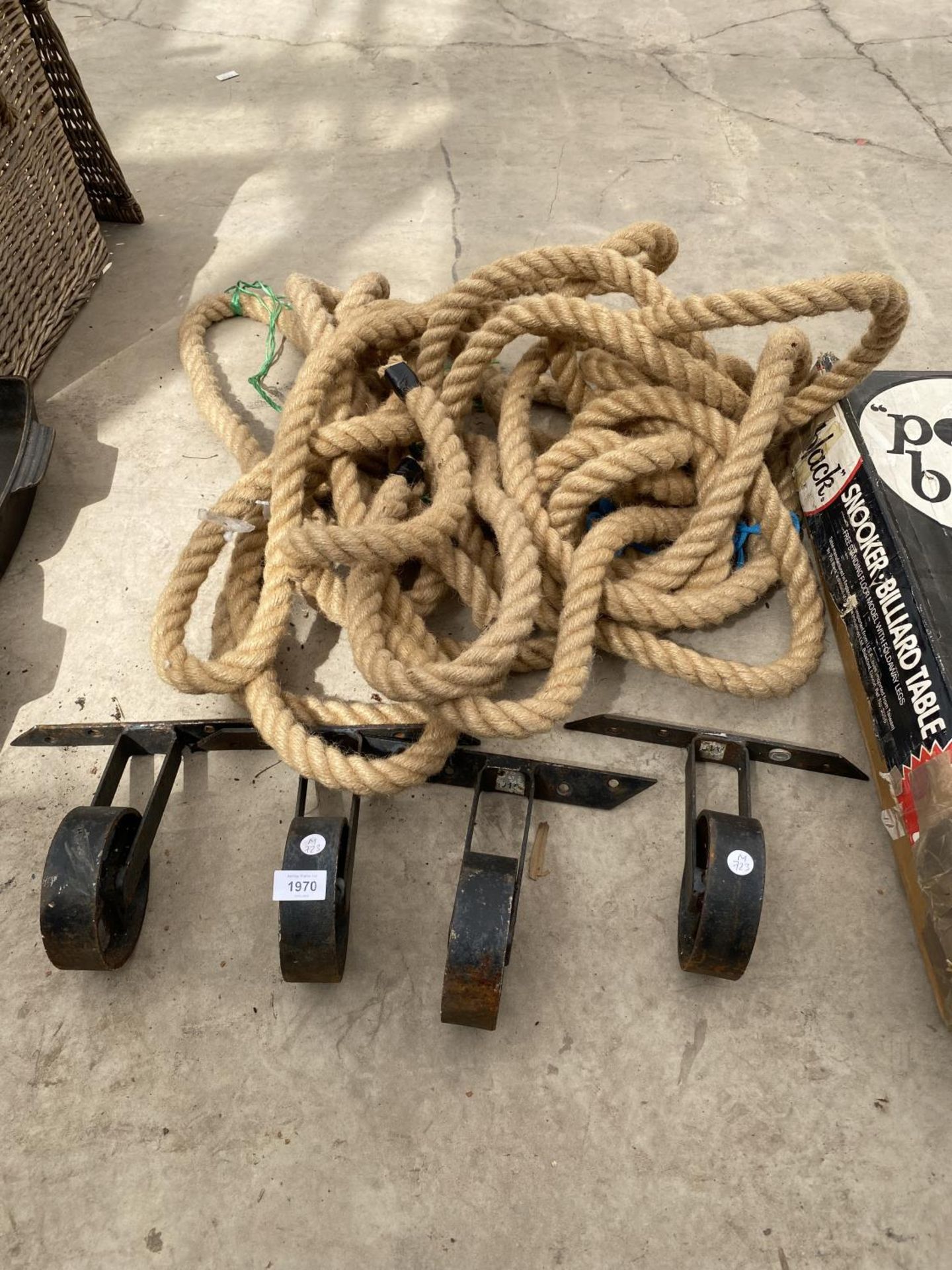 A QUANTITY OF ROPE AND FOUR METAL PULLEY WHEELS