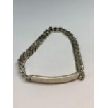 A HEAVY SILVER CURB LINK IDENTITY BRACELET