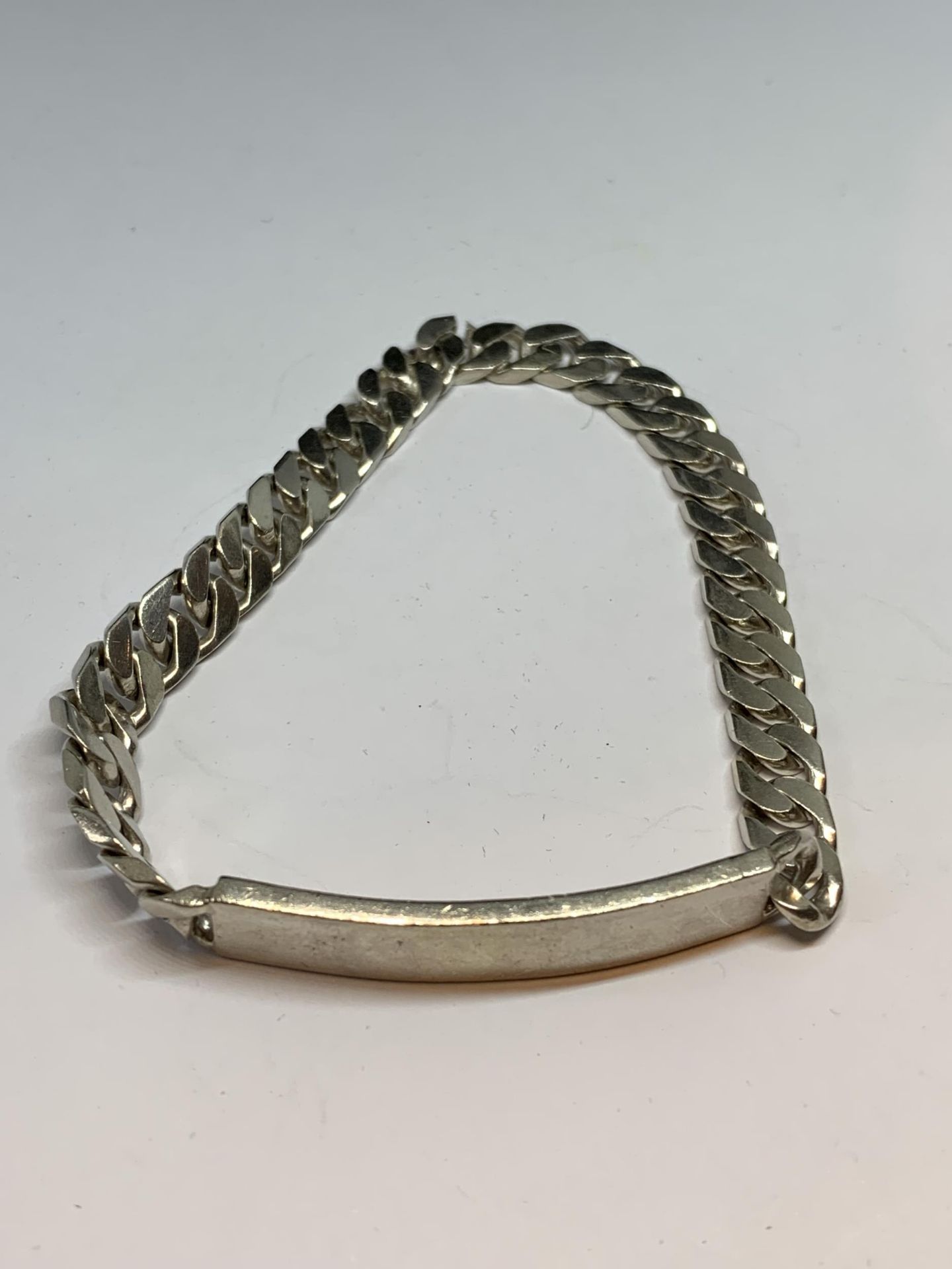 A HEAVY SILVER CURB LINK IDENTITY BRACELET