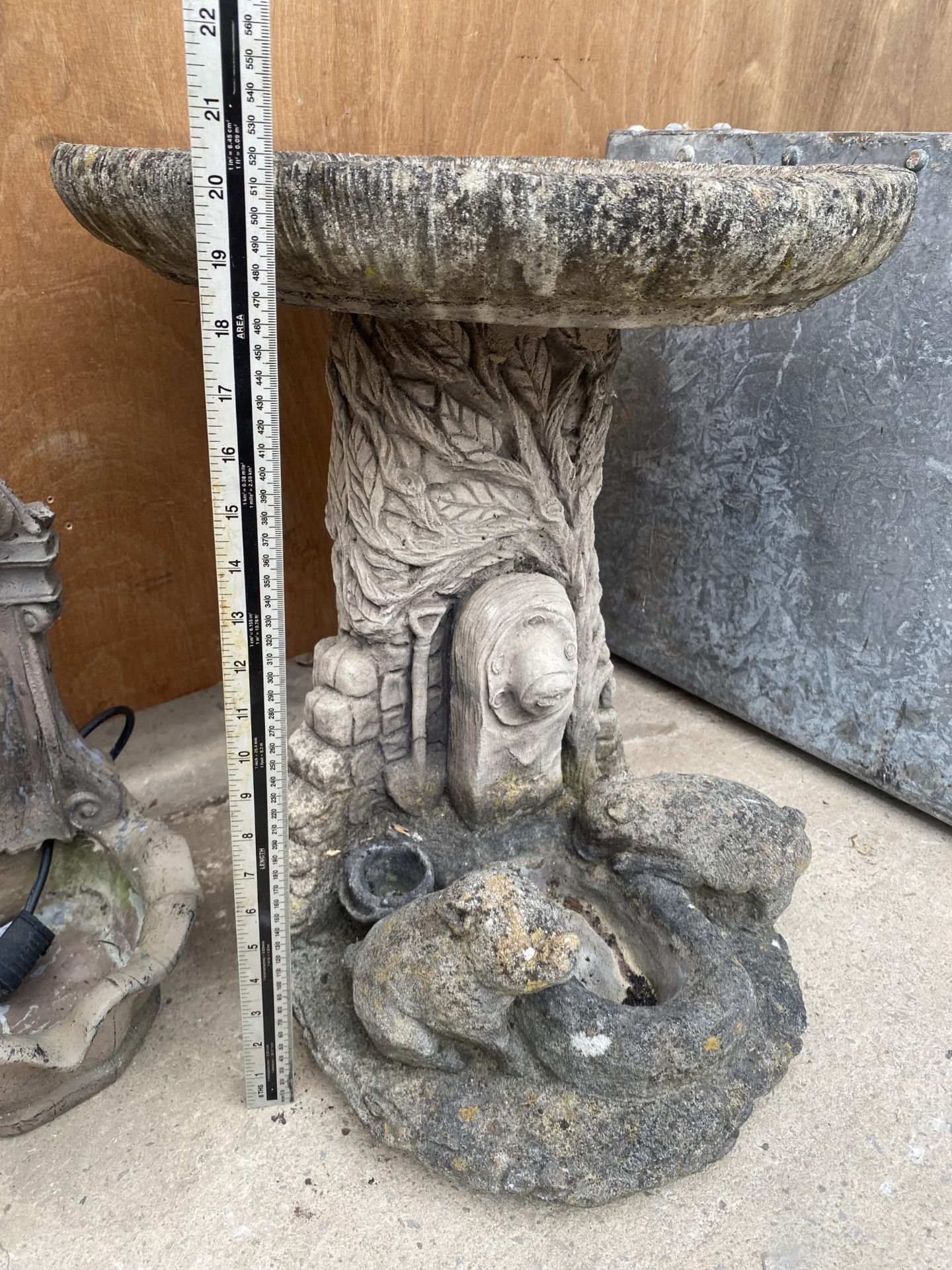 A RECONSTITUTED STONE BIRDBATH WITH PEDESTAL BASE FEATURING ANIMALS AT A TROUGH - Image 3 of 4