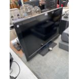 A PANSONIC 32" TELEVISION WITH REMOTE CONTROL AND USER MANUAL