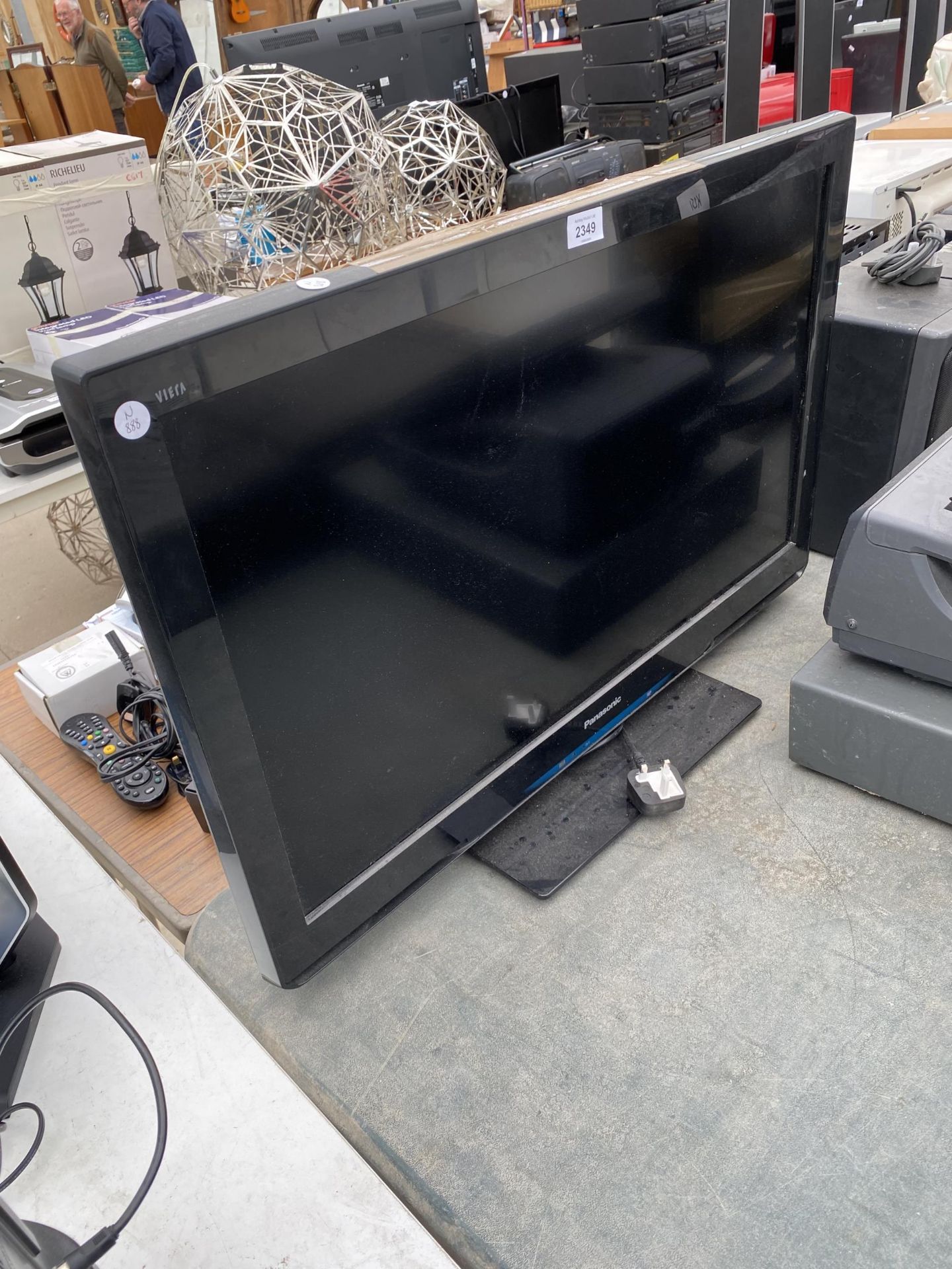 A PANSONIC 32" TELEVISION WITH REMOTE CONTROL AND USER MANUAL