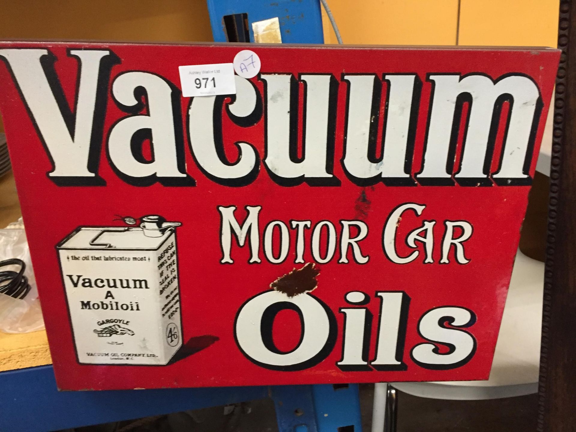 A METAL VACUUM MOTOR CAR OILS SIGN